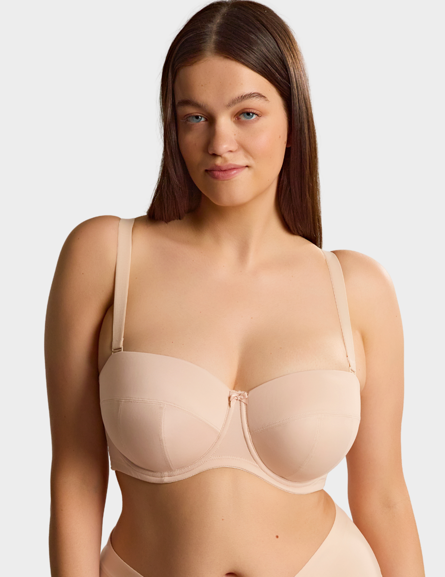 Front view of a model wearing Sculptresse Dana strapless bra in Linen with straps attached
