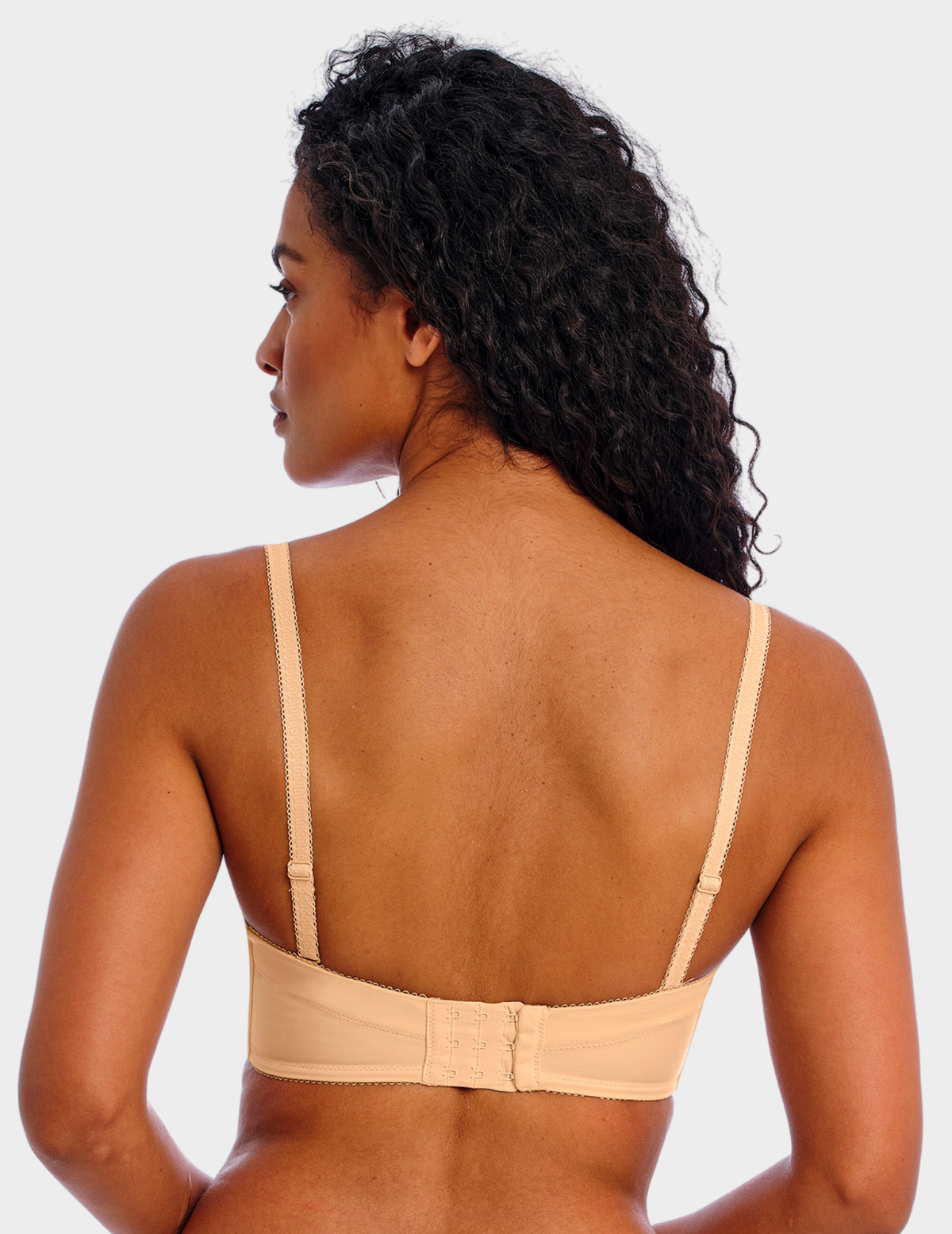 Back view of a model wearing Freya Deco strapless bra in Nude with straps attached