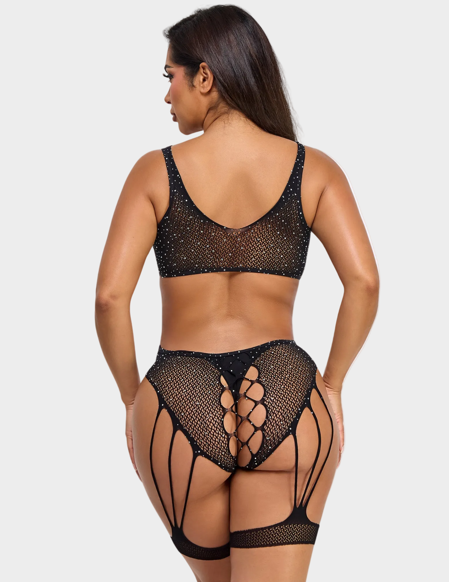 Back view of a model wearing a sparkly black fishnet bodysuit