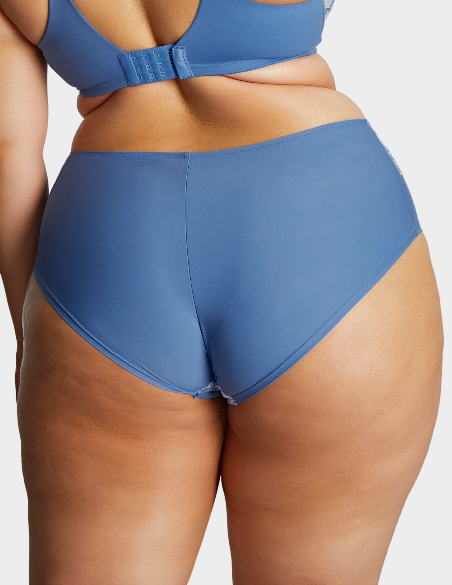 Back view of a model wearing Sculptresse Bliss brief in Blue Floral
