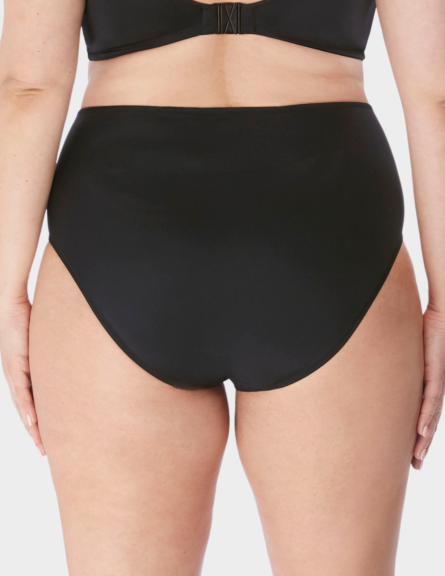 Back view of a model wearing Elomi magnetic swim brief in black