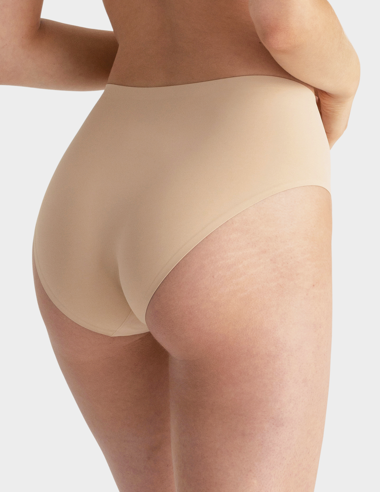 Back view of a model wearing Evelyn & Bobbie high waist brief in Sand