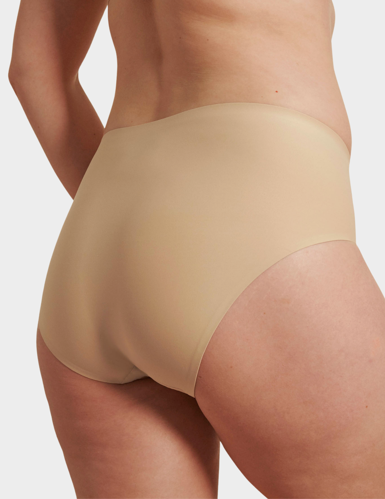 Back view of a model wearing Evelyn & Bobbie high waist brief in Sand