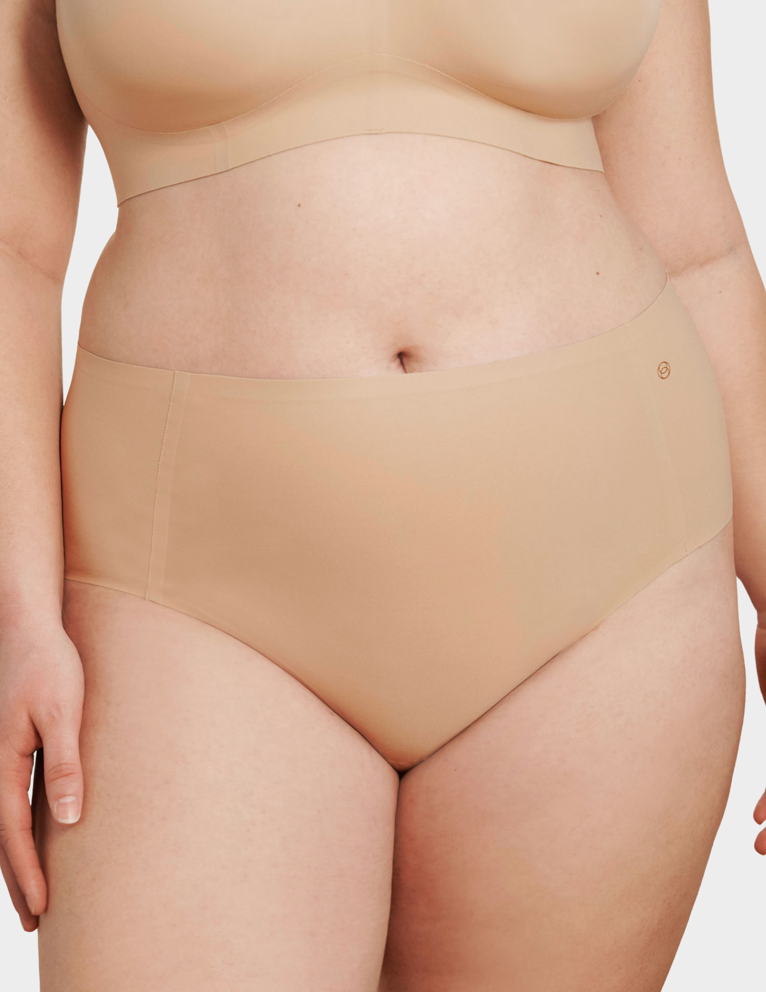 Front view of a model wearing Evelyn & Bobbie high waist brief in Sand