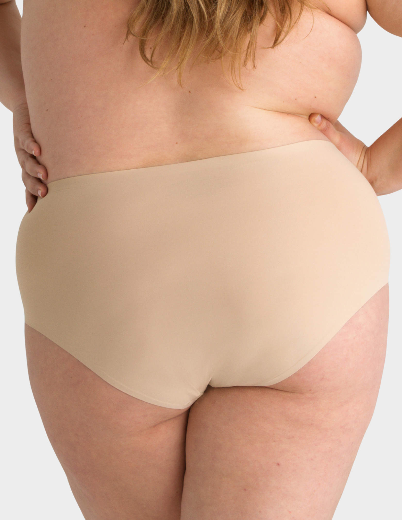 Back view of a model wearing Evelyn & Bobbie high waist brief in Sand