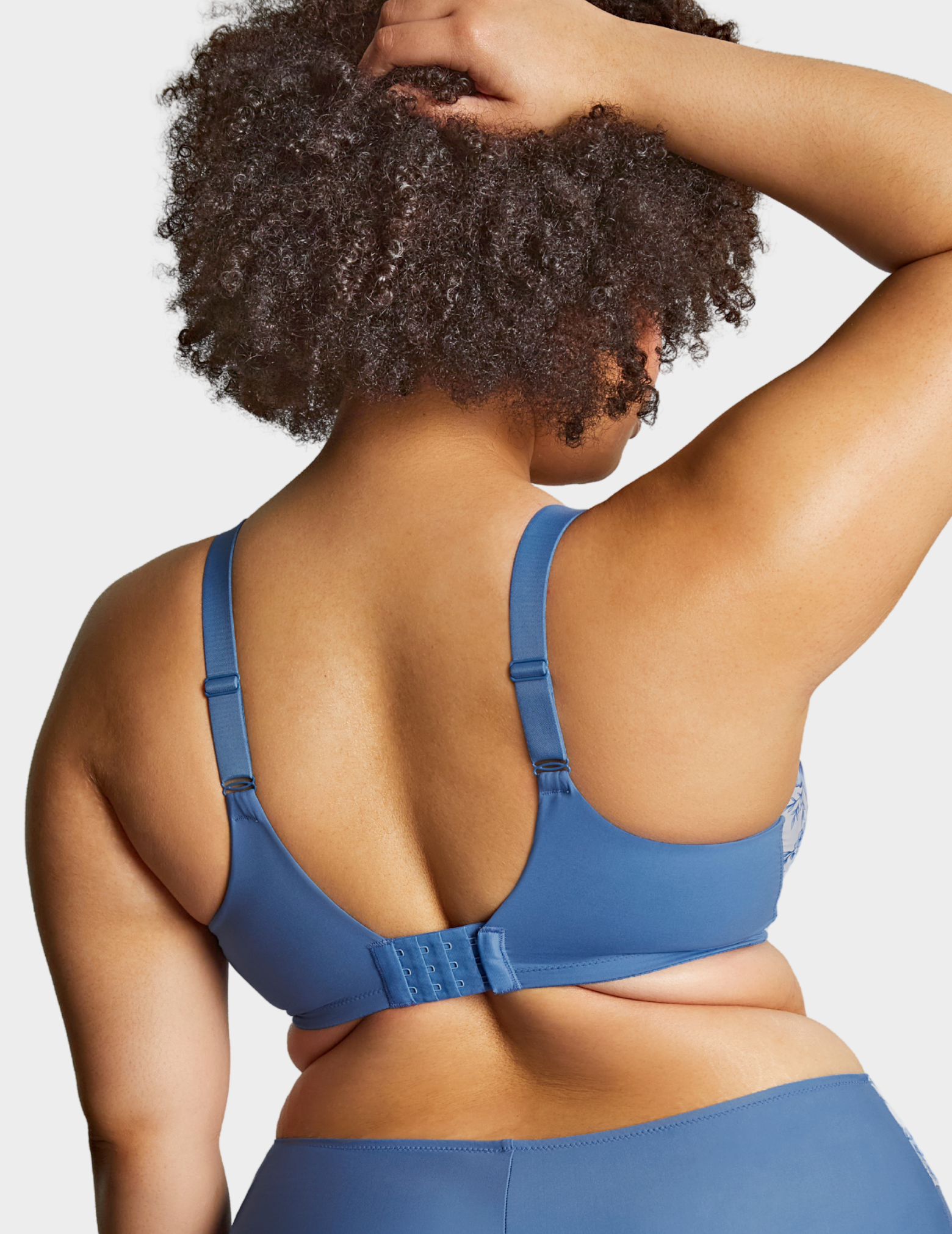 Back view of a model wearing Sculptresse Bliss bra in Blue Floral