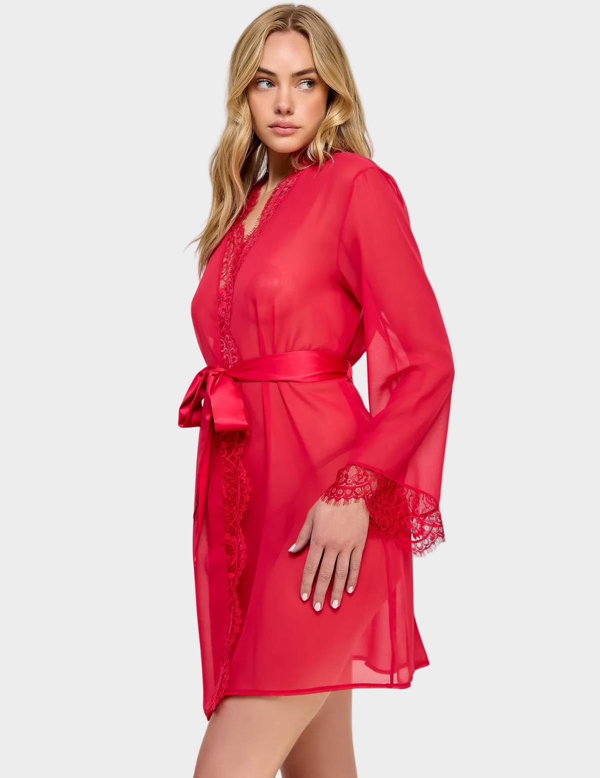 Side view of a model wearing a semi-sheer red robe with lace trim