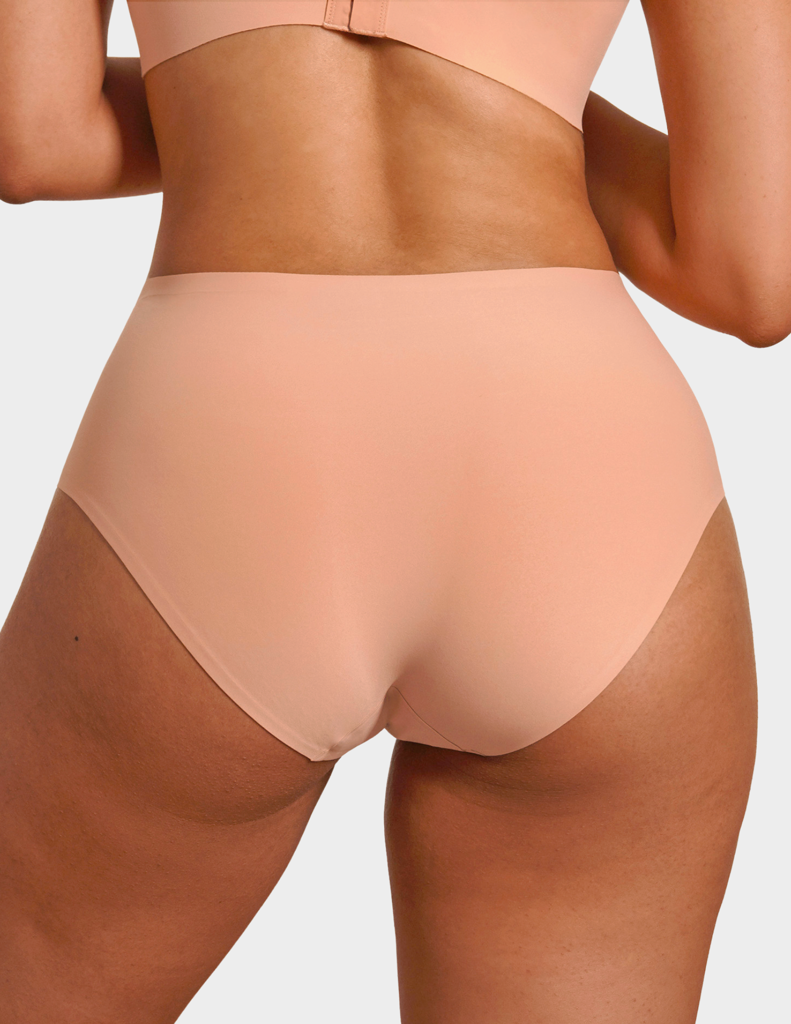 Back view of a model wearing Evelyn & Bobbie high waist brief in Himalayan Salt