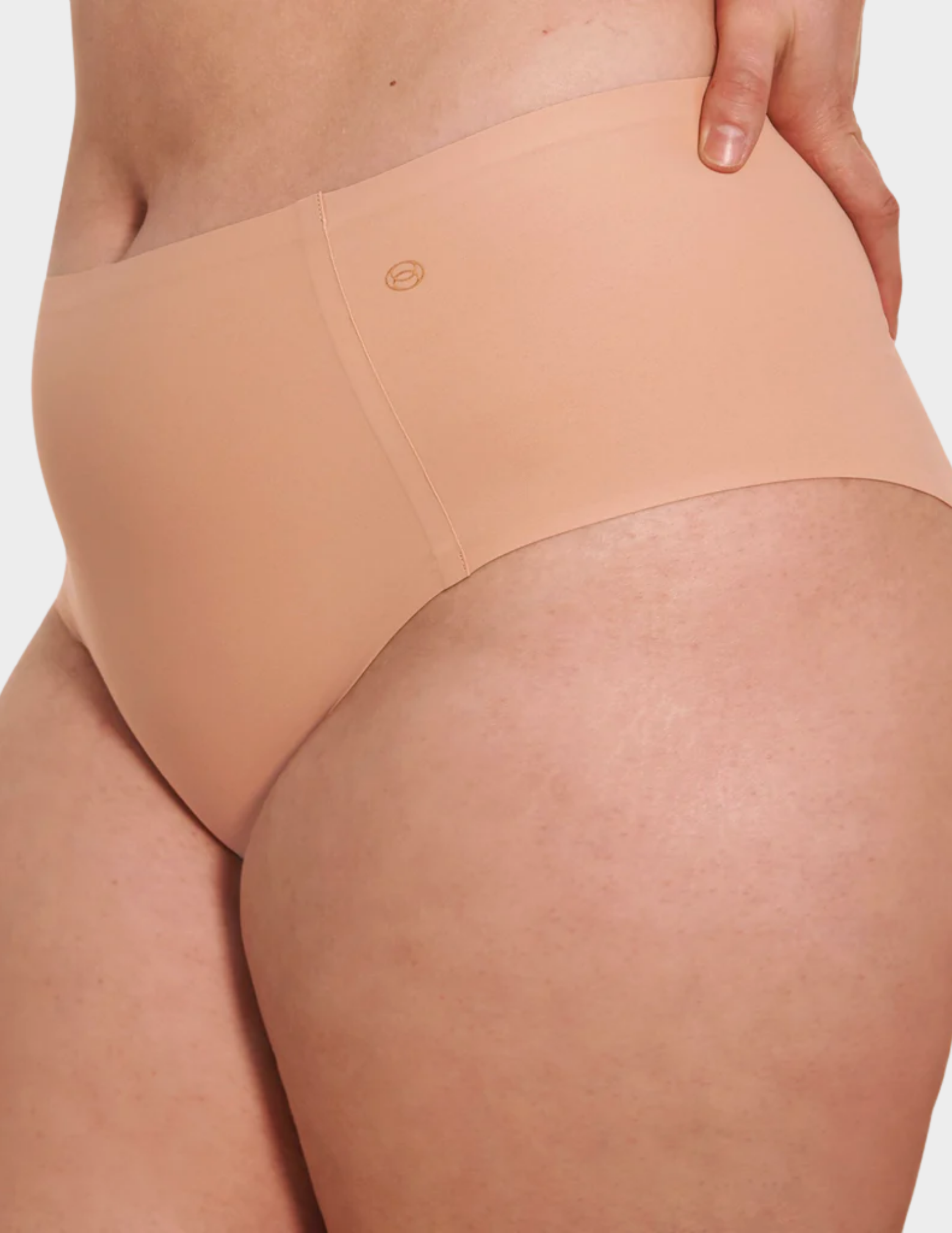 Side view of a model wearing Evelyn & Bobbie high waist brief in Himalayan Salt