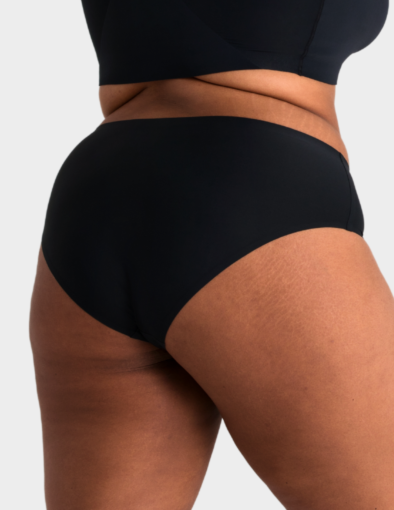 Back view of a model wearing Evelyn & Bobbie high waist brief in Black