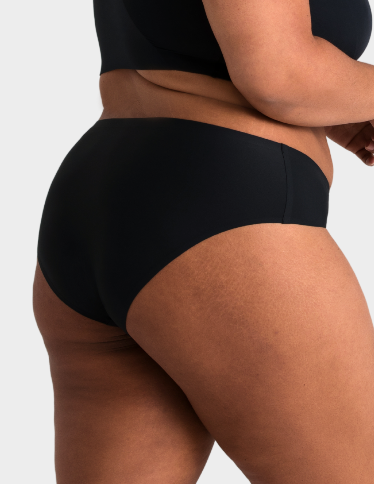 Side view of a model wearing Evelyn & Bobbie high waist brief in Black