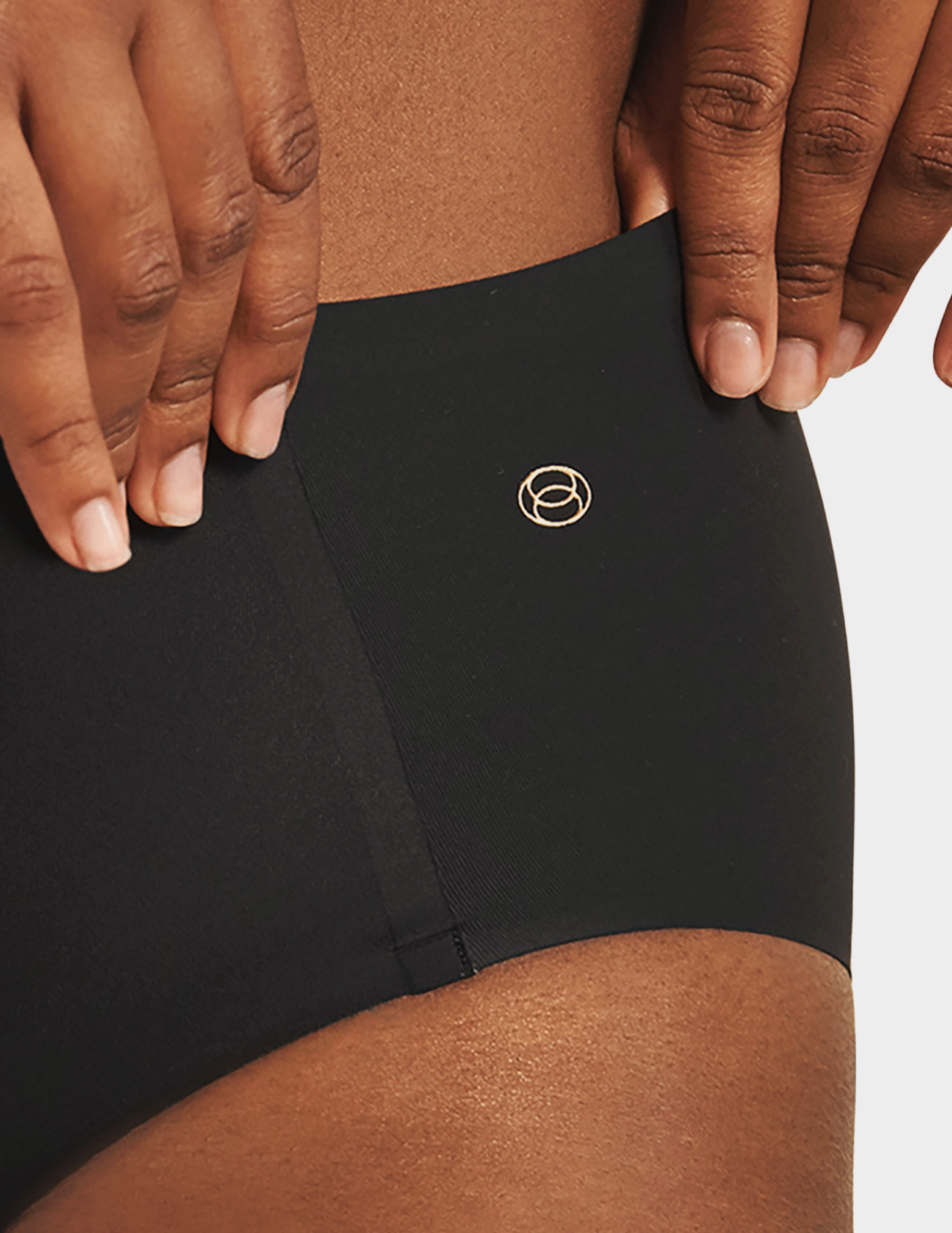 Close up front view of a model wearing Evelyn & Bobbie high waist brief in Black