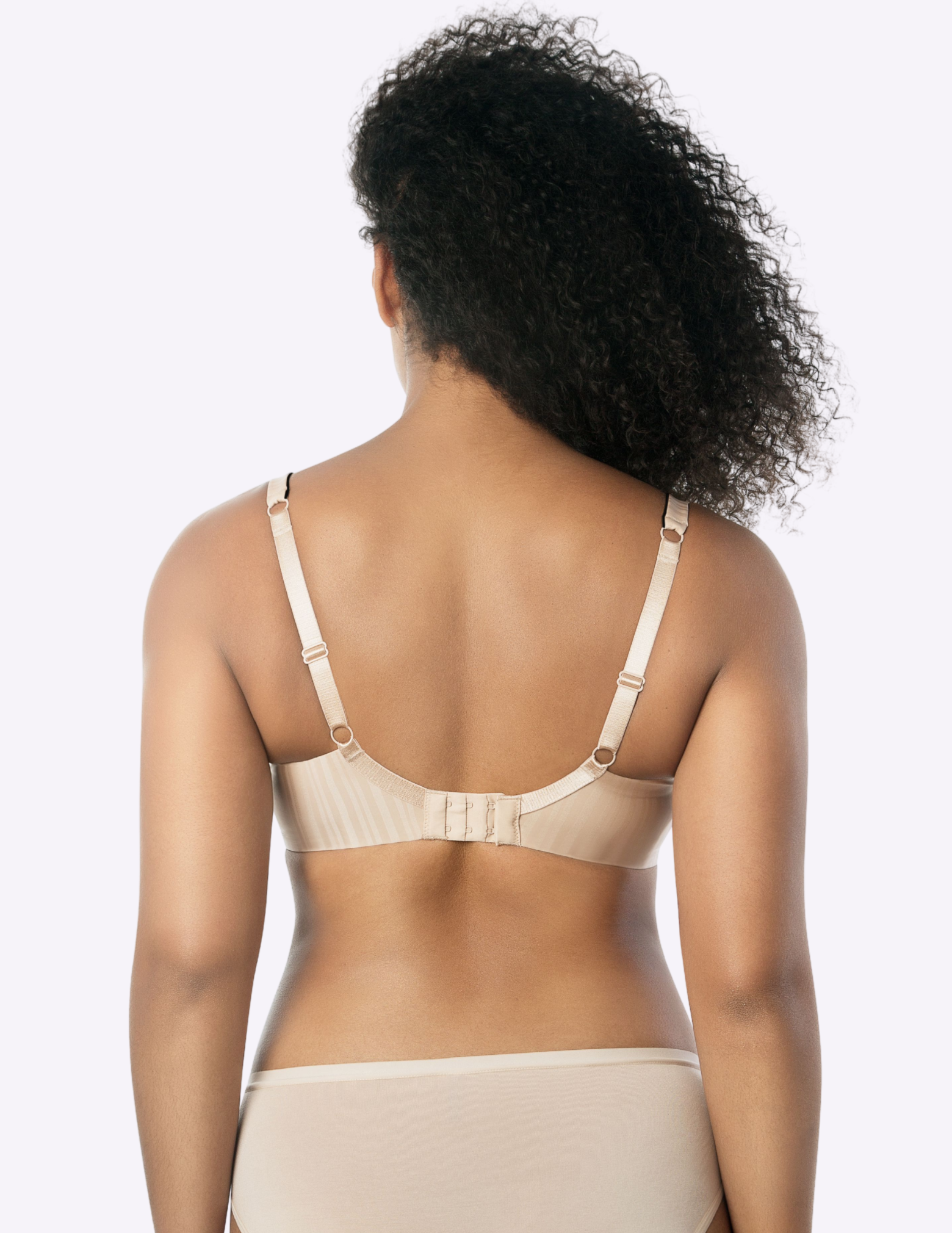 Back view of a model wearing beige and black Aline t-shirt bra