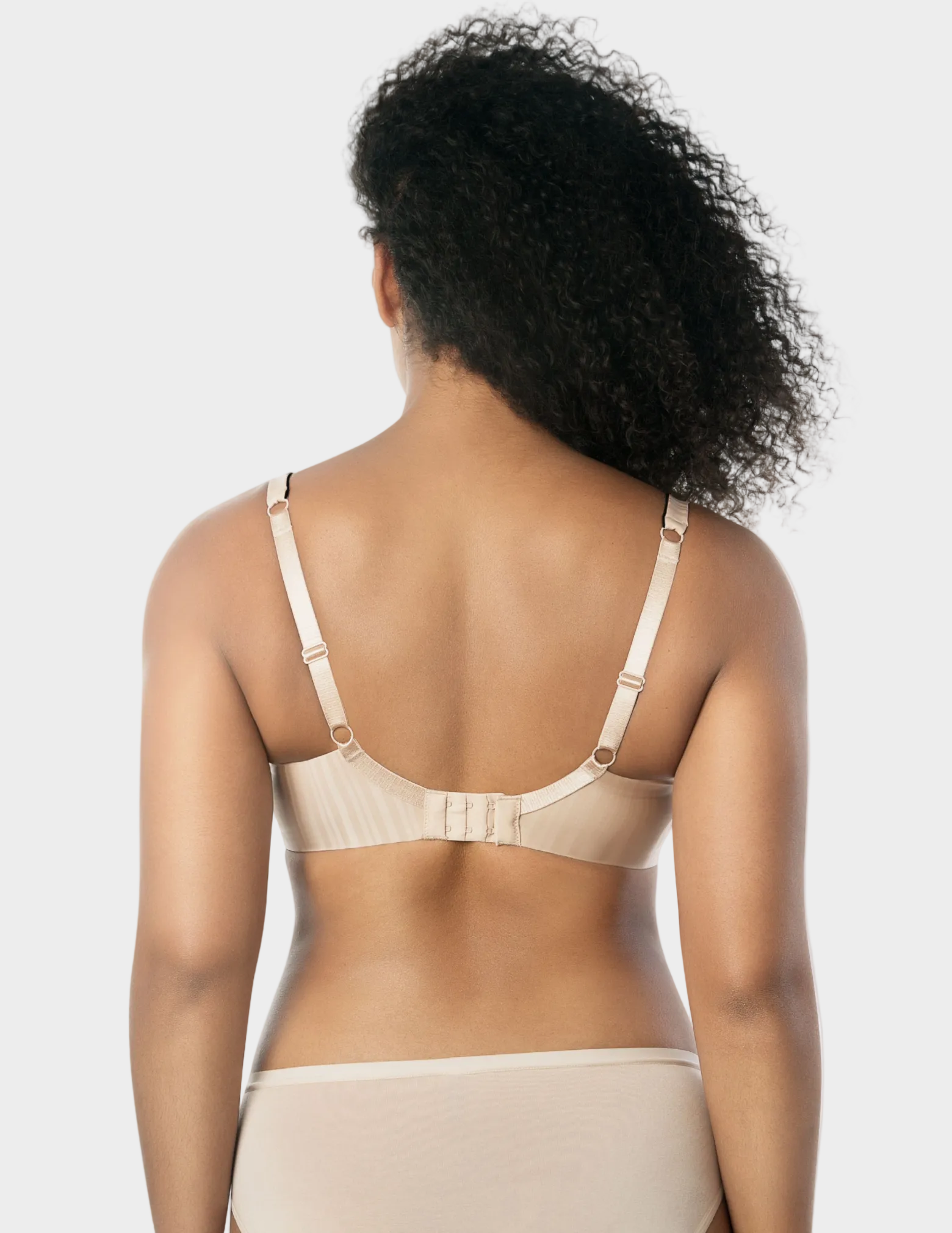 Back view of a model wearing beige and black Aline t-shirt bra