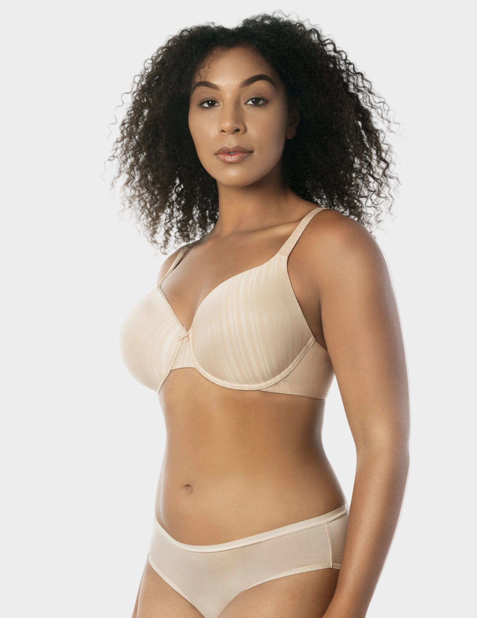 Side view of a model wearing beige Aline t-shirt bra