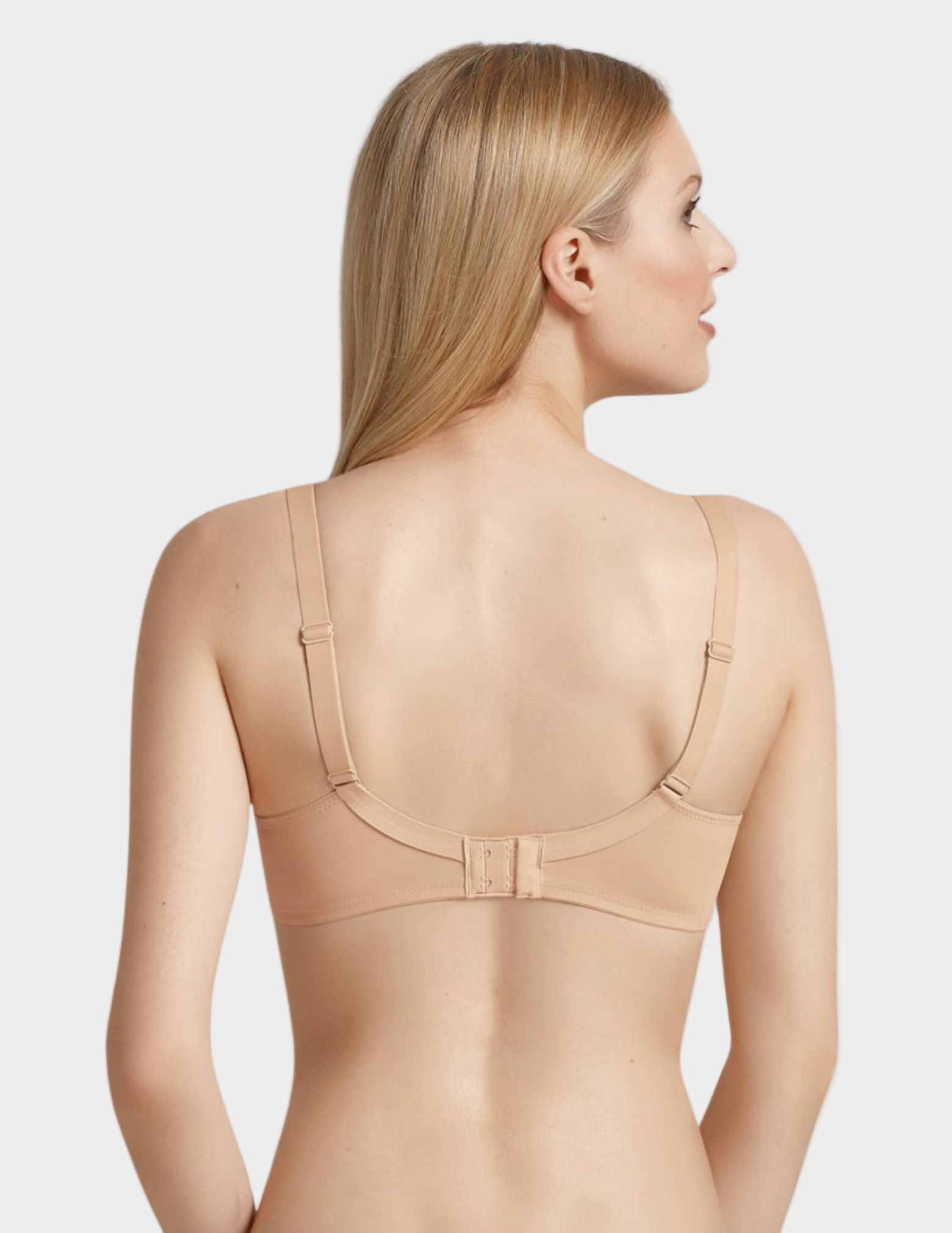 Woman wearing a beige bra on a white background