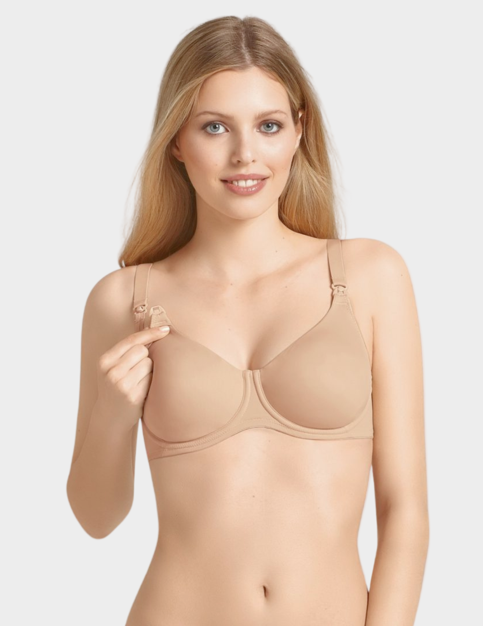 Woman wearing a beige nursing bra on a white background