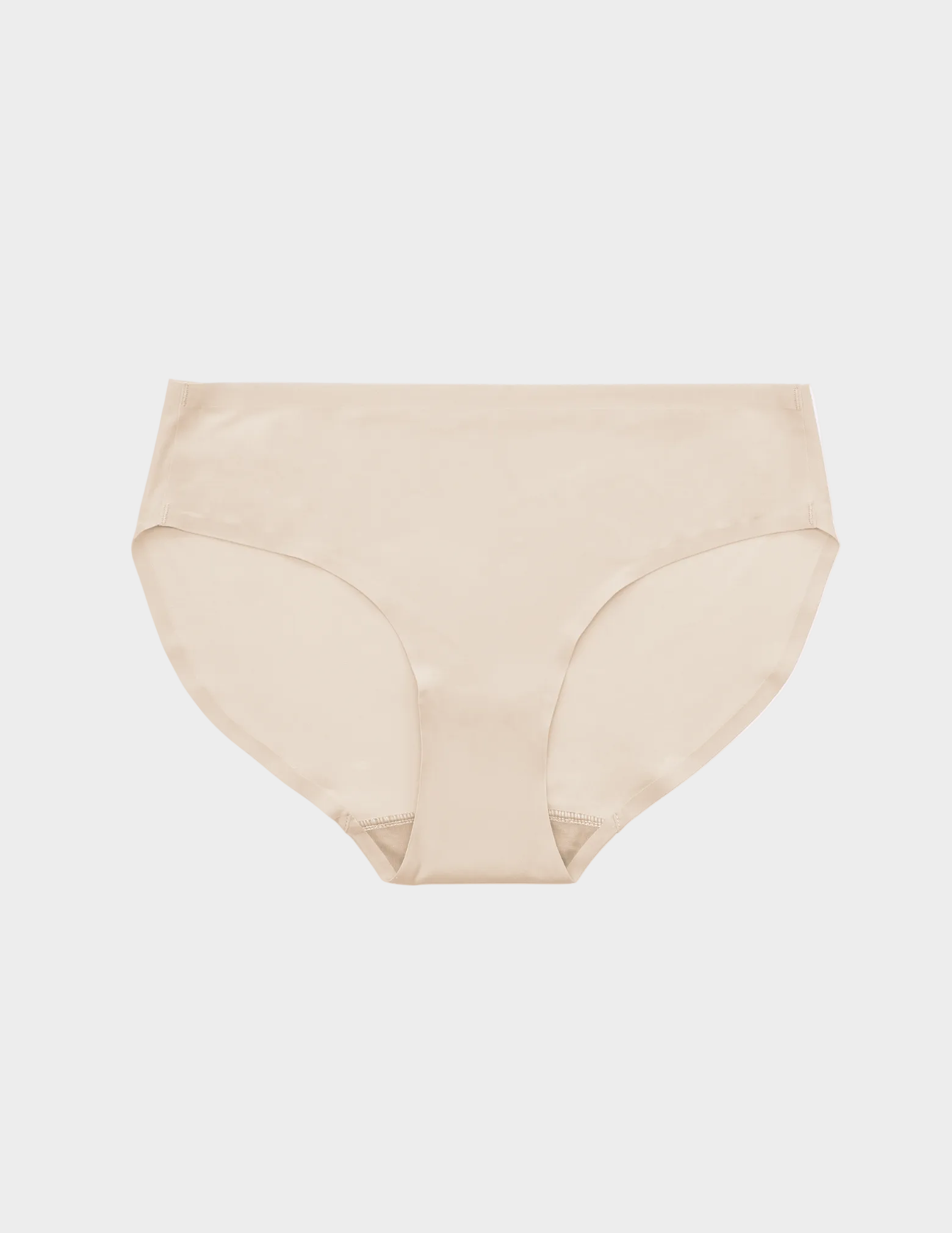 flat lay of light beige seamless underwear on a white background