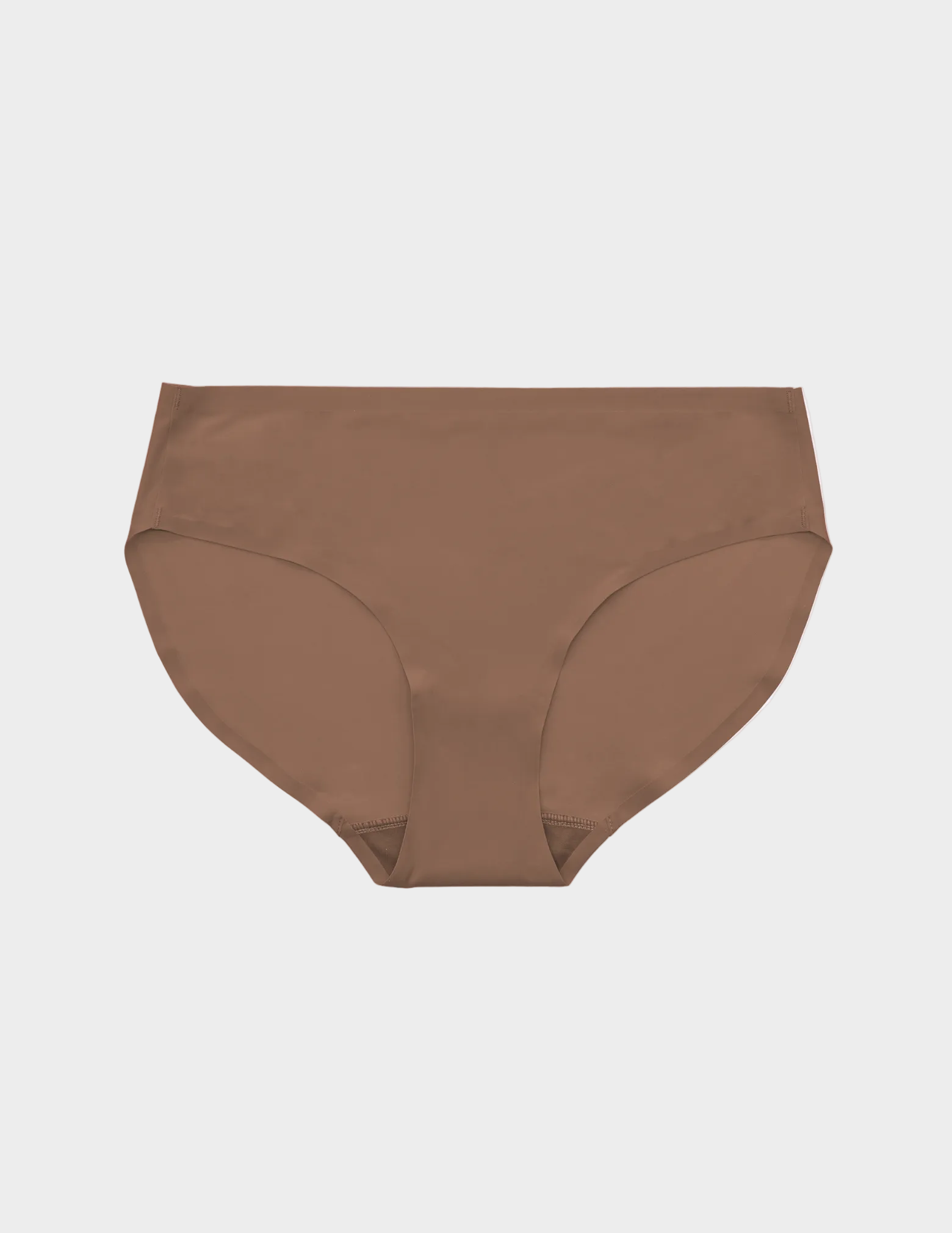 Flat lay of medium brown colored seamless underwear on a white background