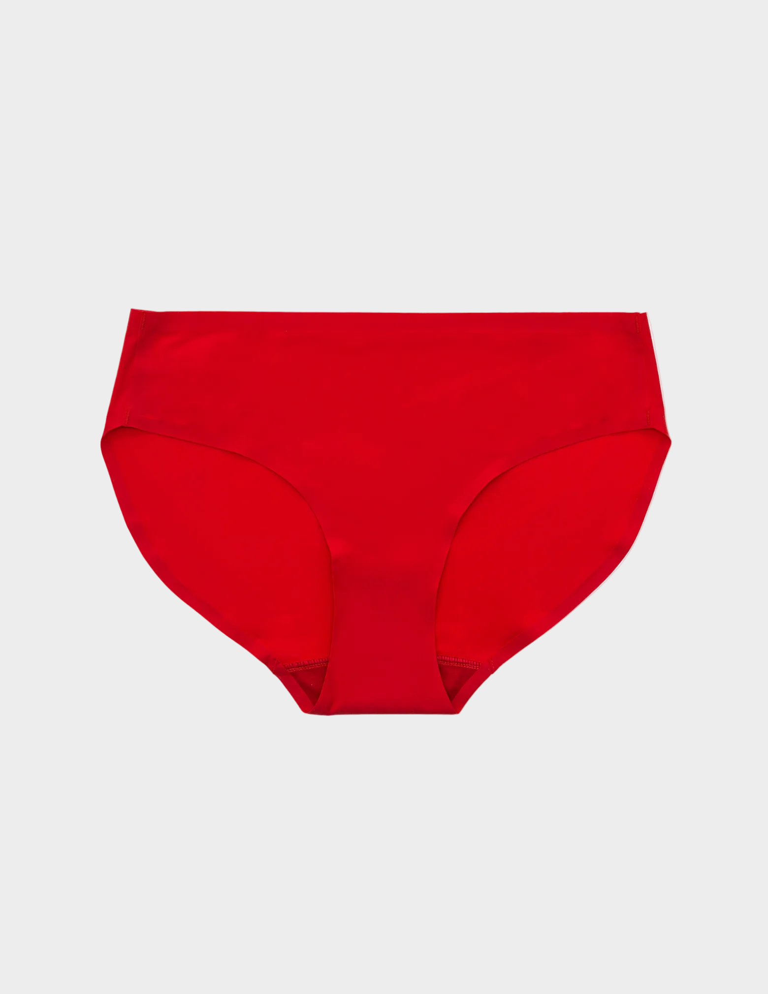 Flat lay of bright red seamless hipster underwear on a whit ebackground