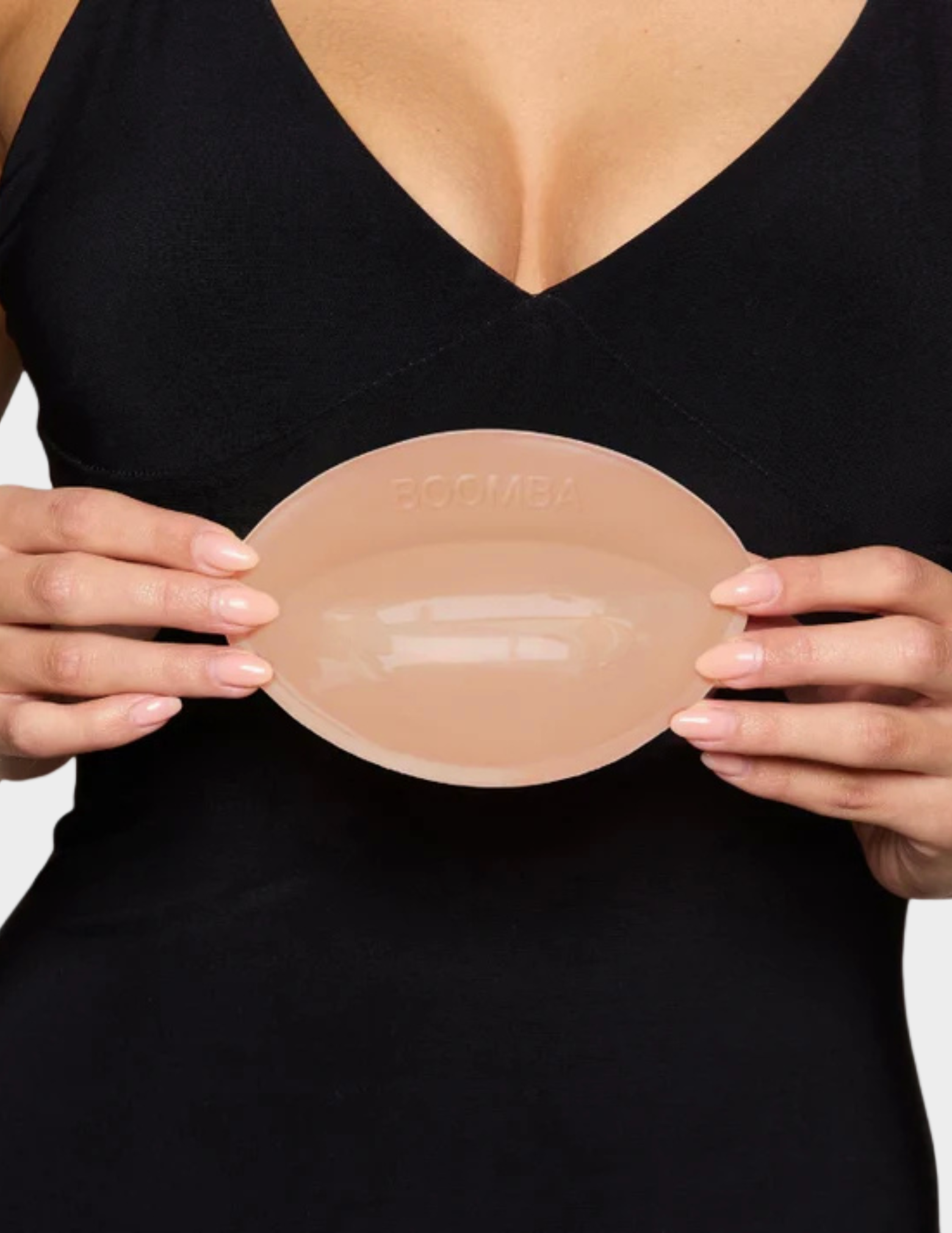 closeup of woman holding boomba bra insert