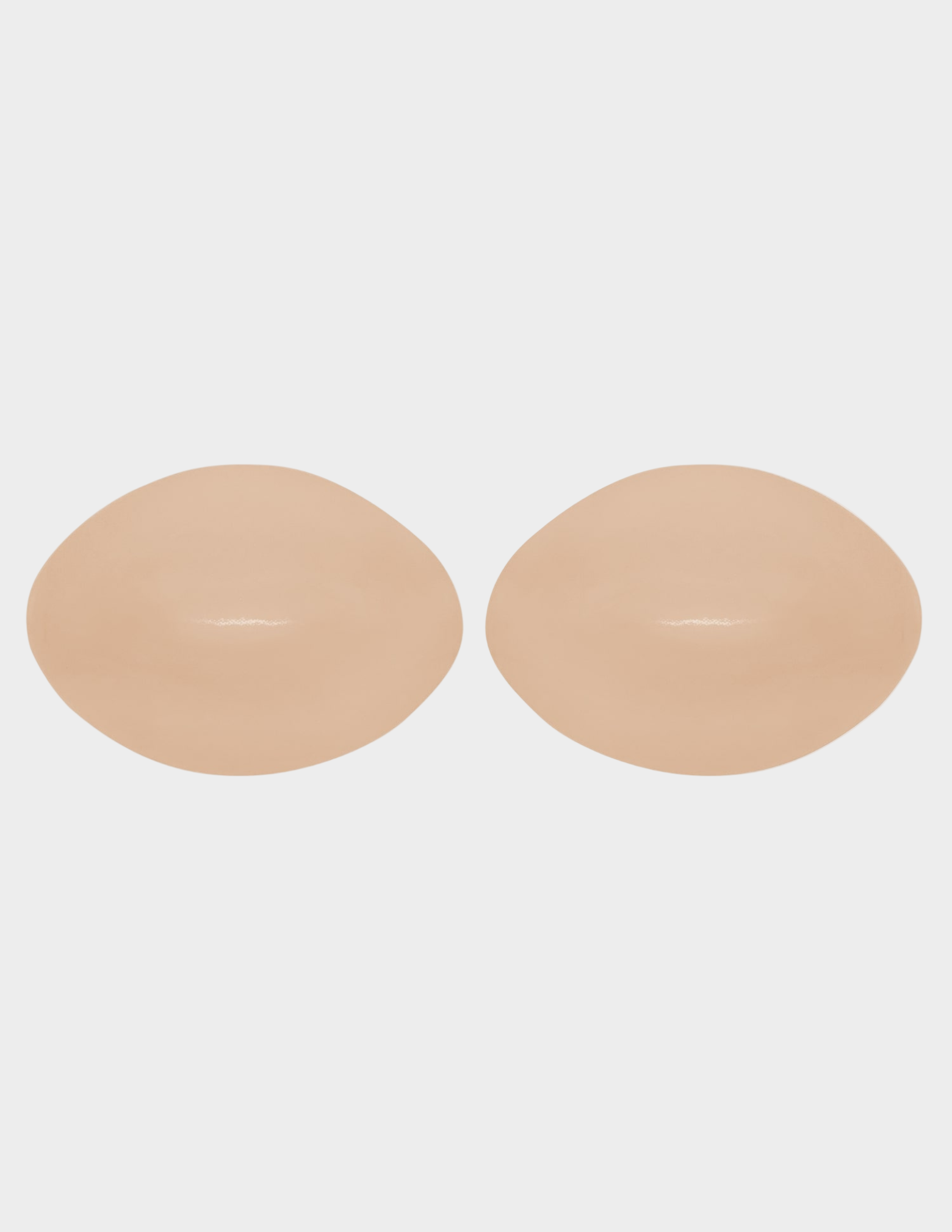 beige bra inserts on white background