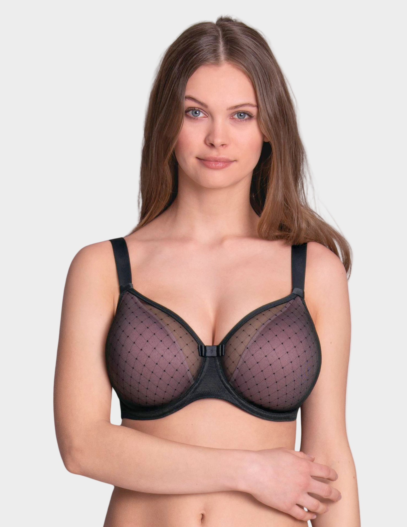 Woman wearing a black and pink bra against a plain background