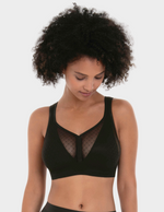 Woman wearing a black bralette on a white background