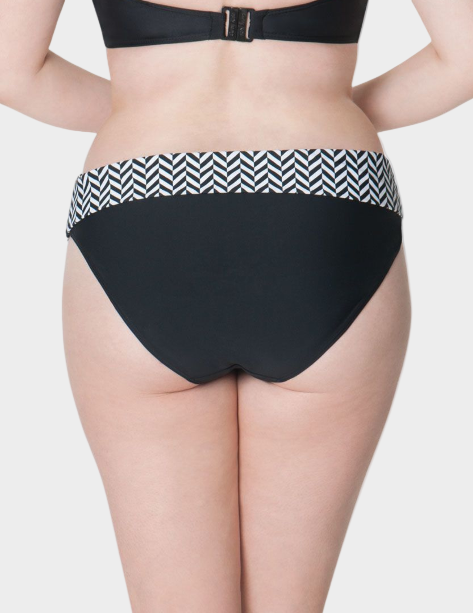 back view of woman wearing black and white geometric print fold over swim bottom