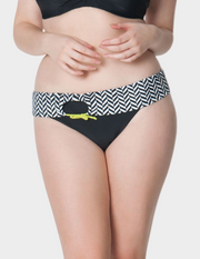 woman wearing black and white geometric print fold over swim bottom
