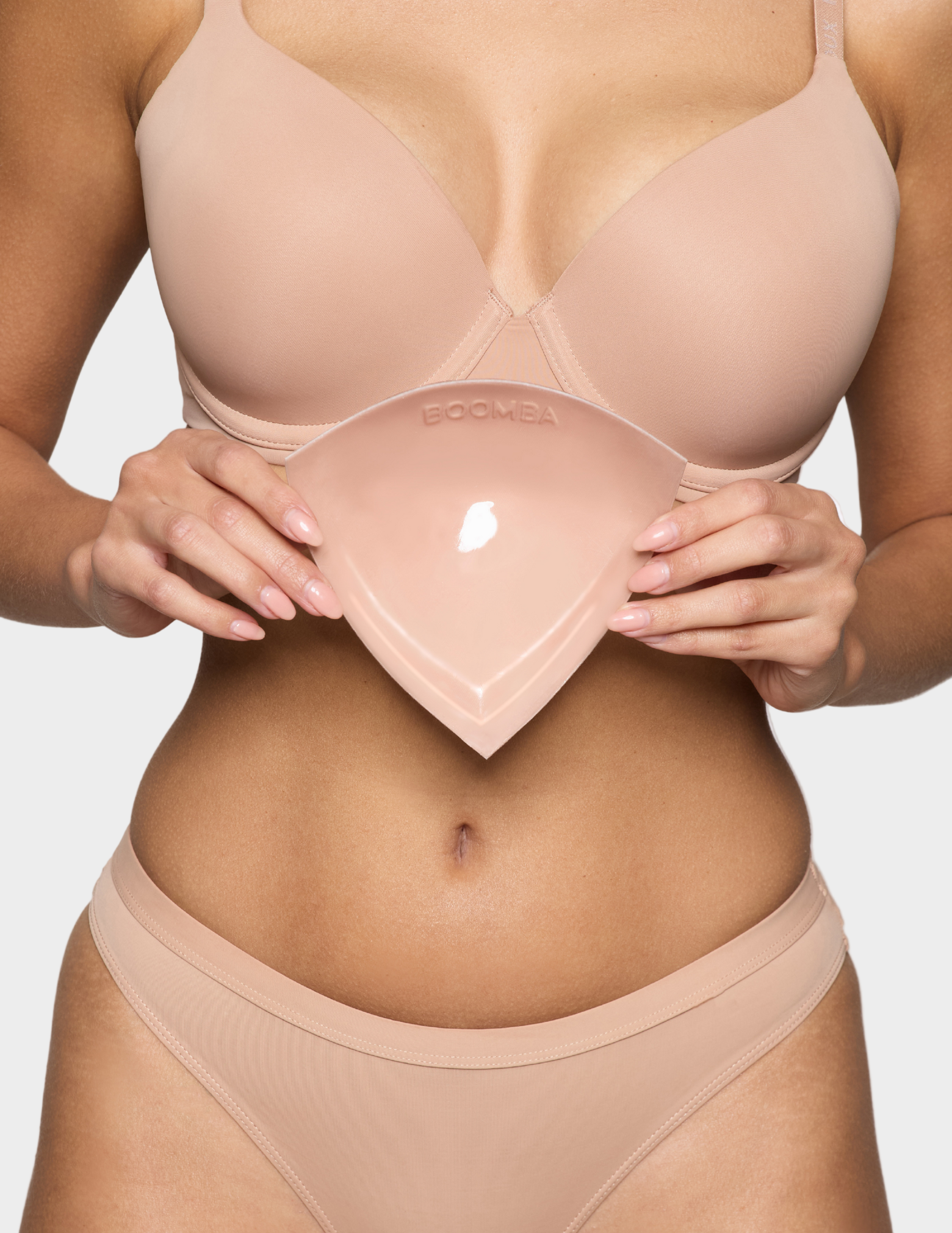 closeup of woman holding beige bra insert