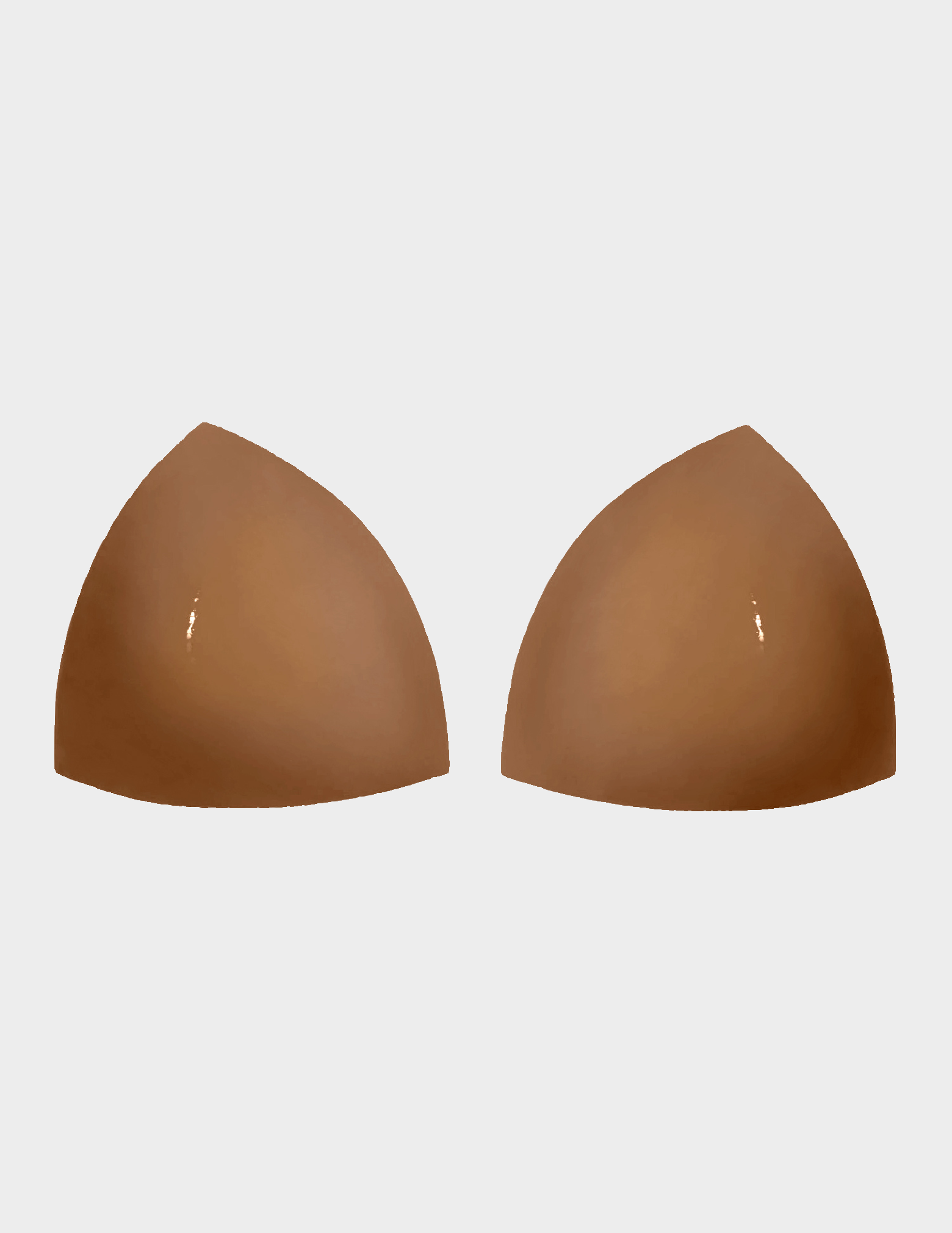 pair of tan colored bra inserts on white background 