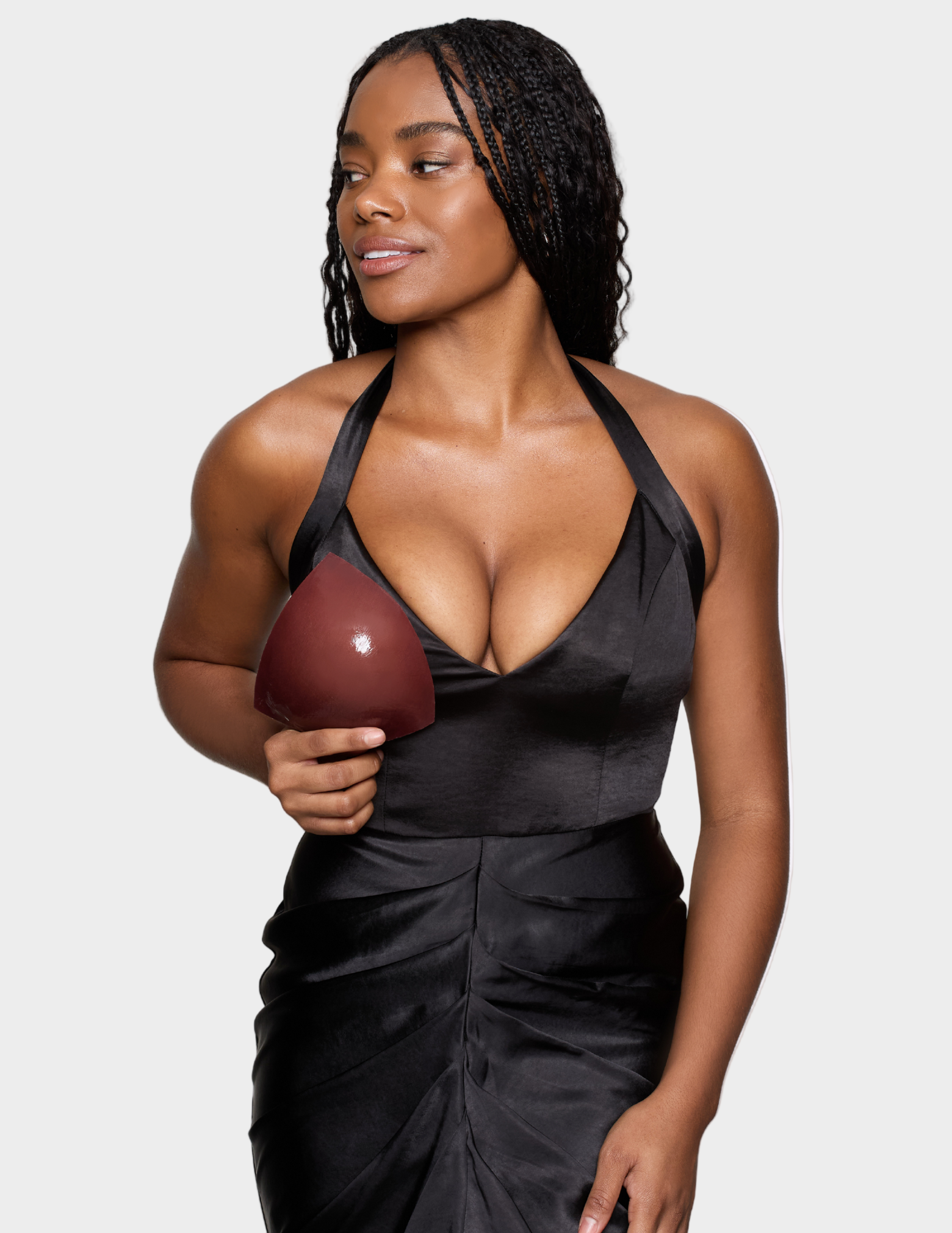 woman in black dress holding brown bra insert