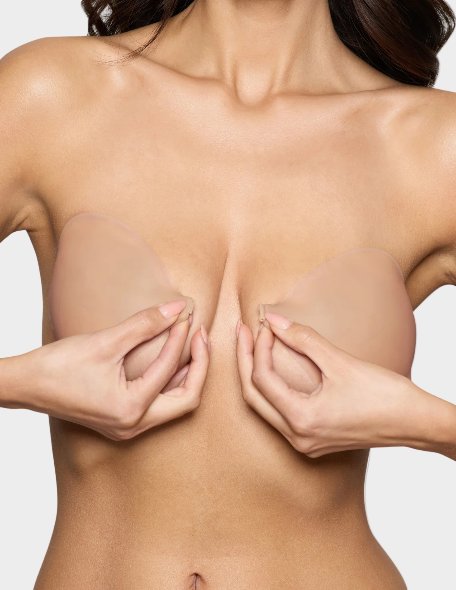 woman about to clasp beige backless front close sticky bra