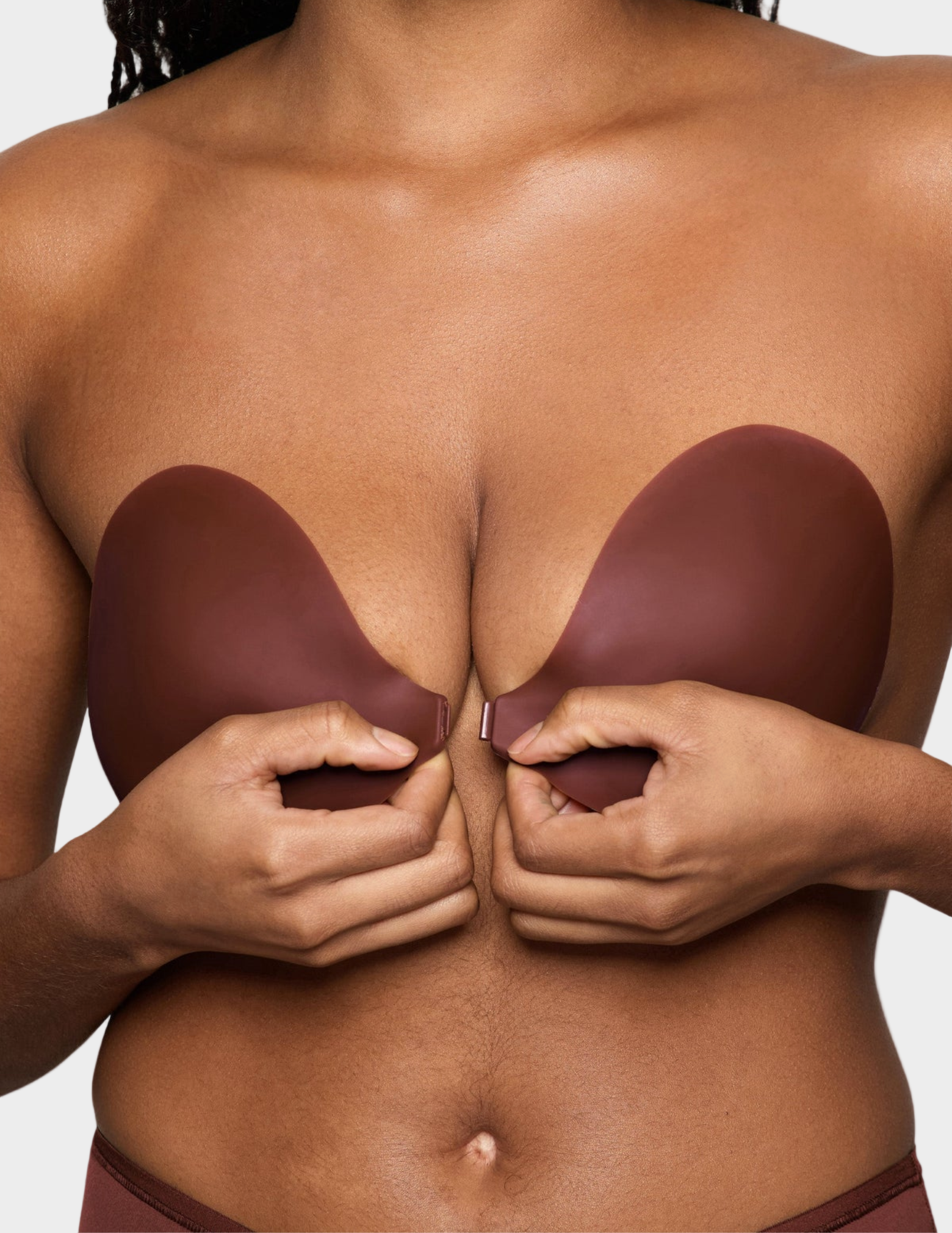 woman clasping brown front close sticky bra