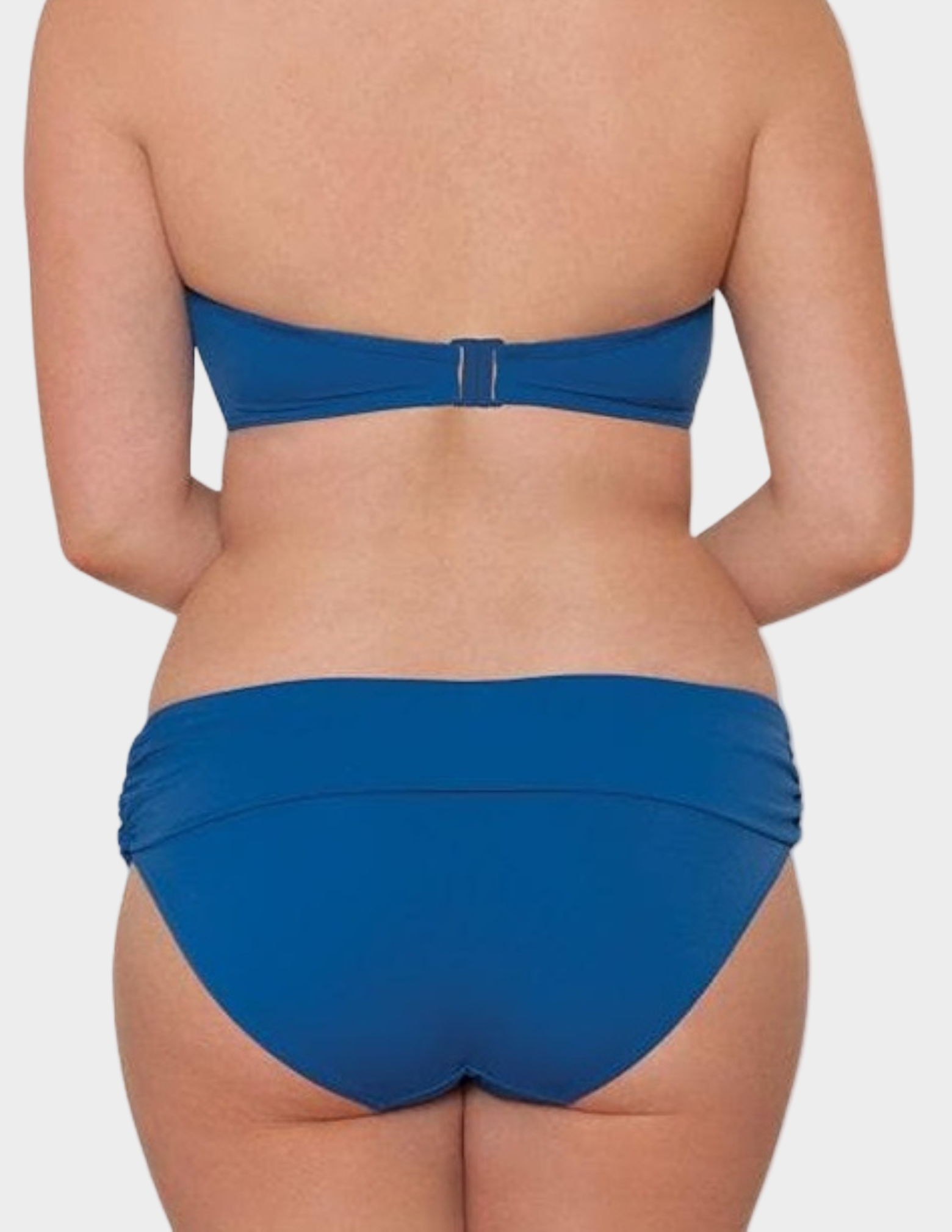 back view of woman wearing blue fold over swim bottom