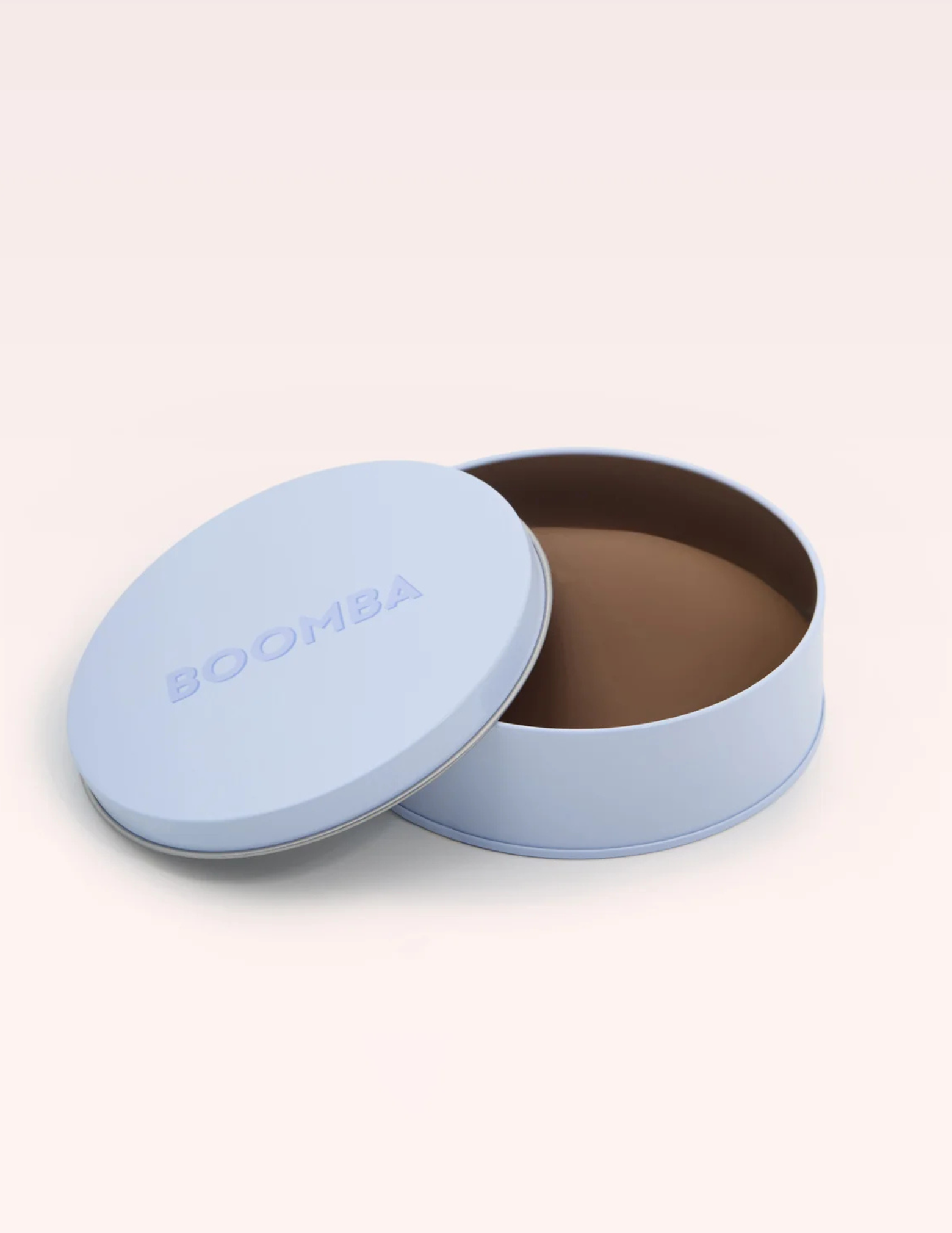 round blue container labeled BOOMBA with brown nipple covers inside