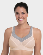 Woman wearing a beige and gray sports bra on a white background