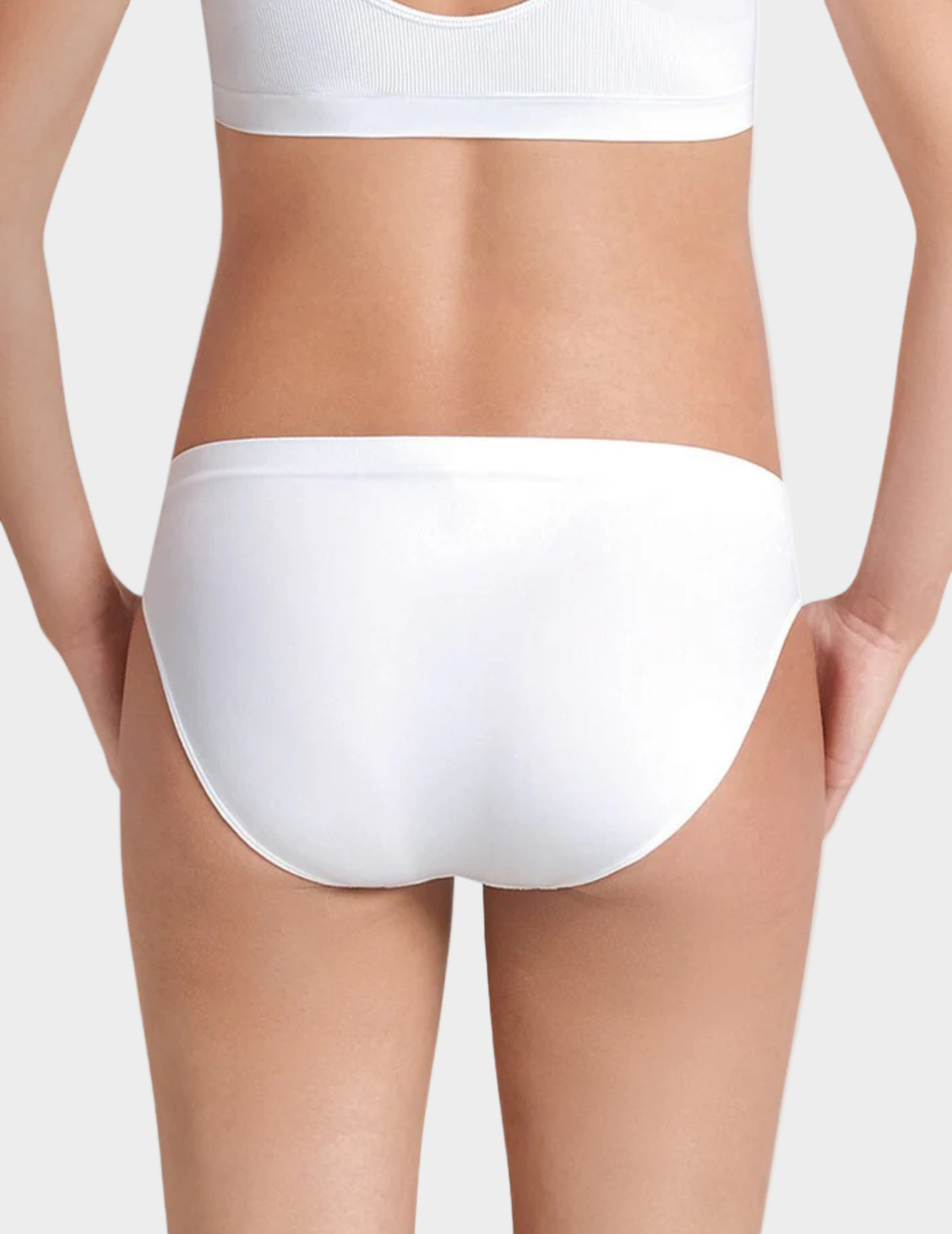 back view of woman wearing White underwear on a plain background