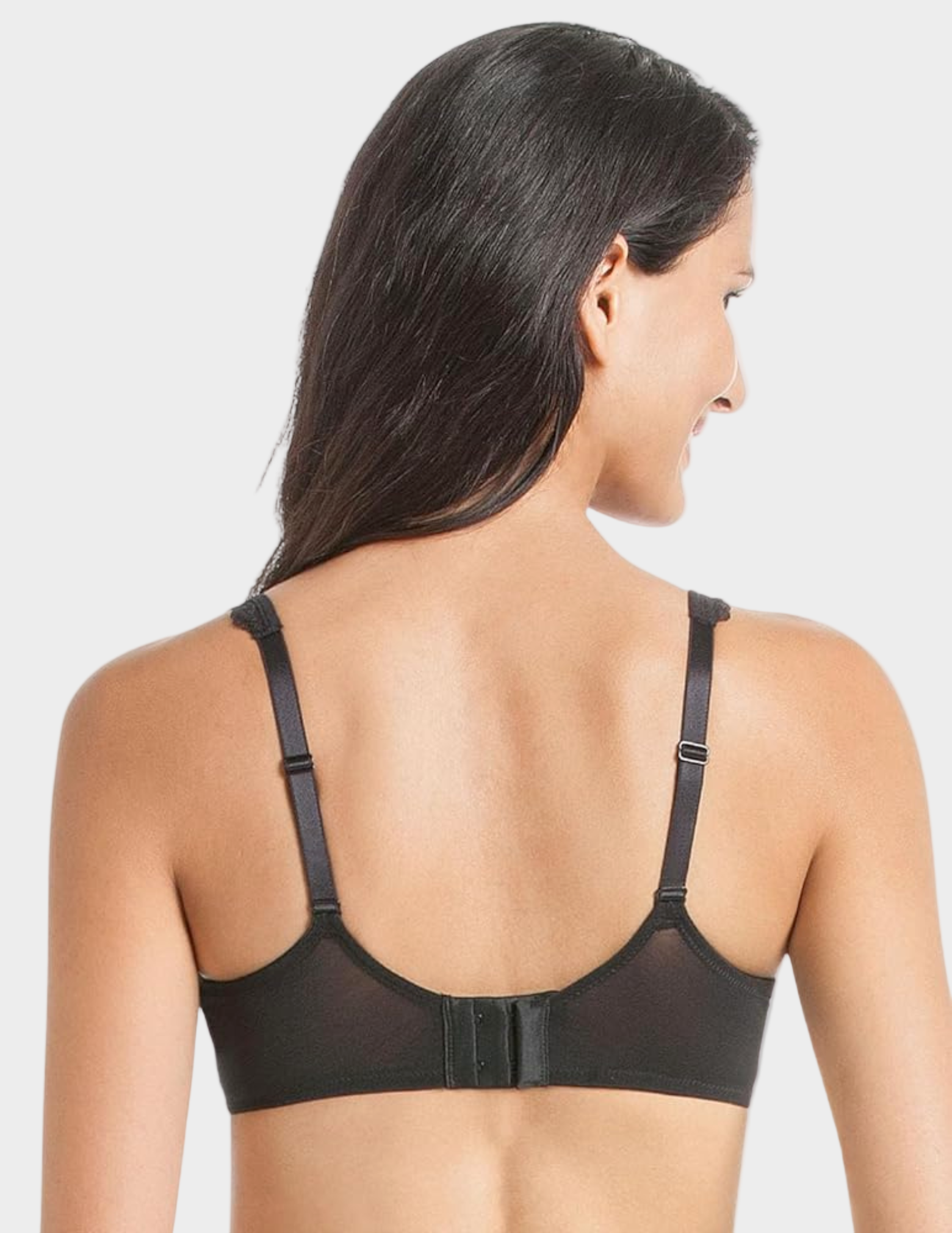 Woman wearing a black bra on a white background