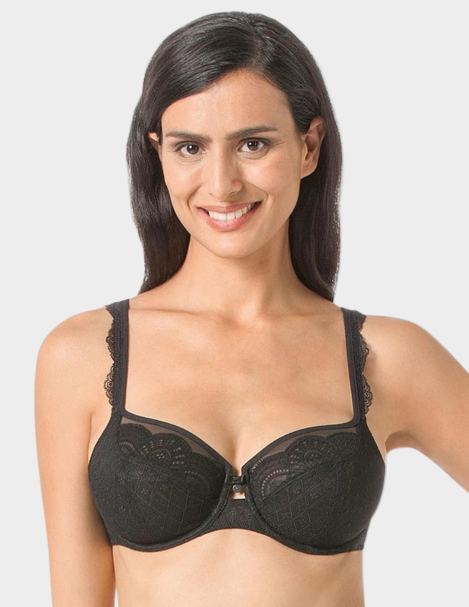 Woman wearing a black lace bra against a white background