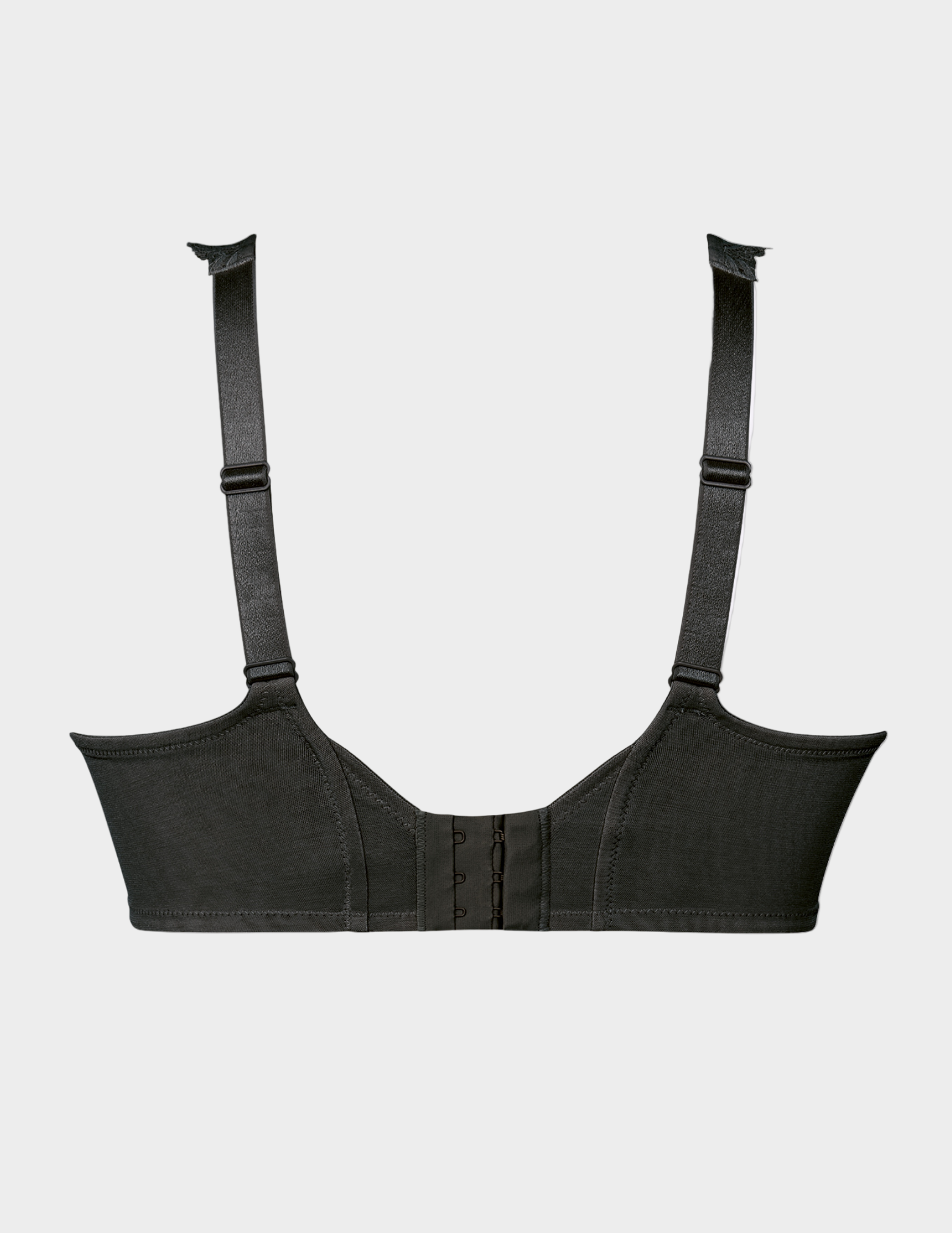 Black bra with straps on a light gray background