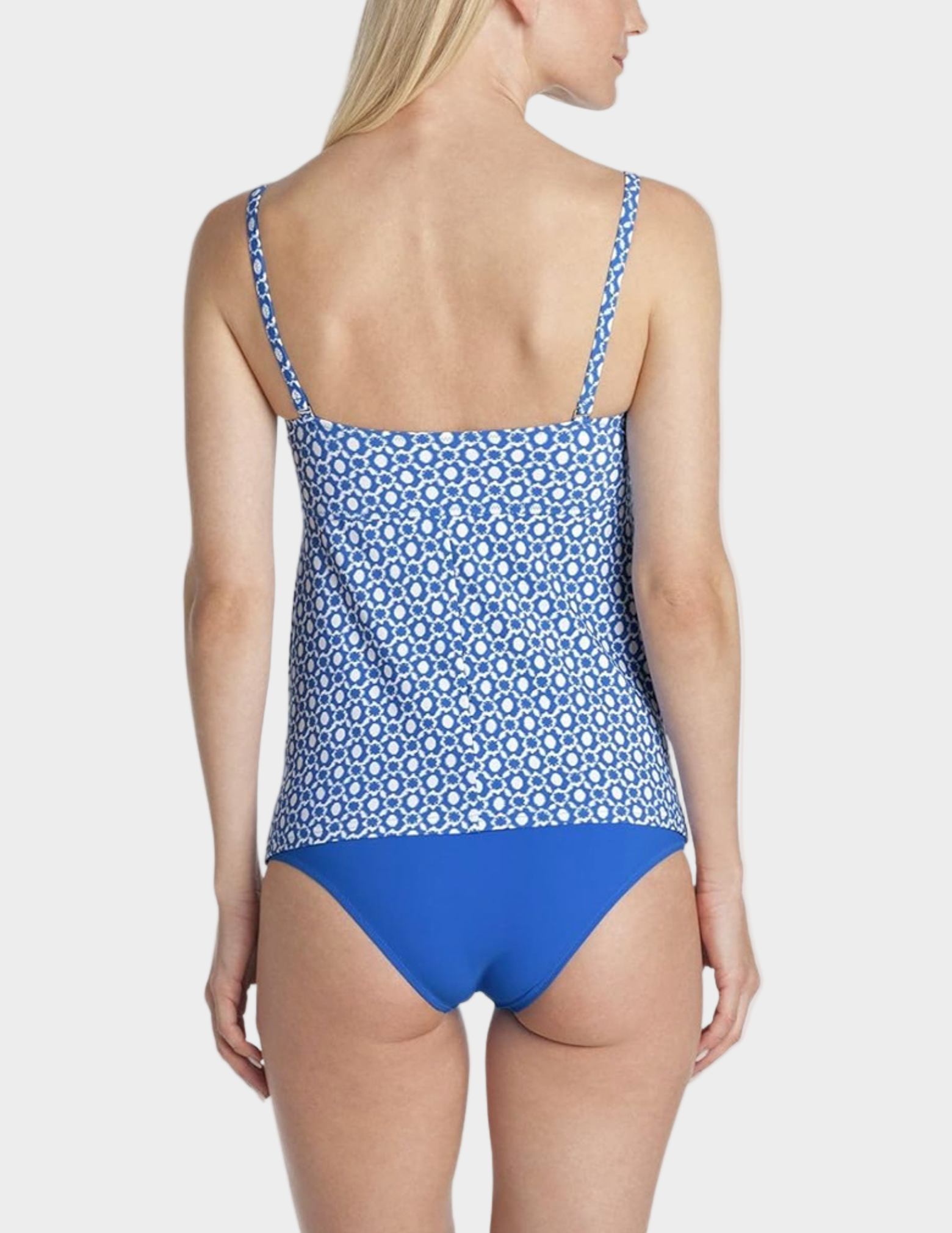 Woman wearing a blue and white patterned swimsuit on a white background