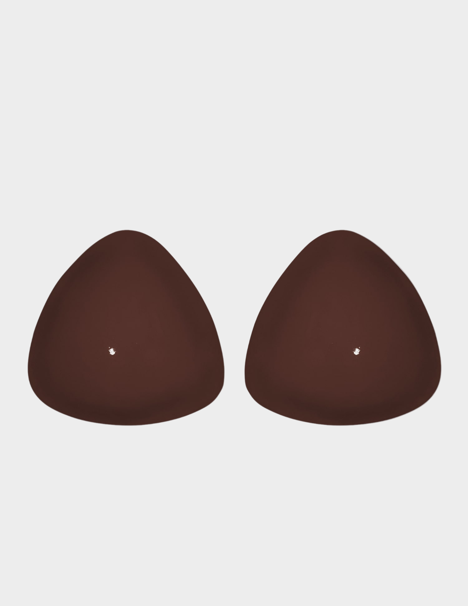 pair of brown bra inserts on white background