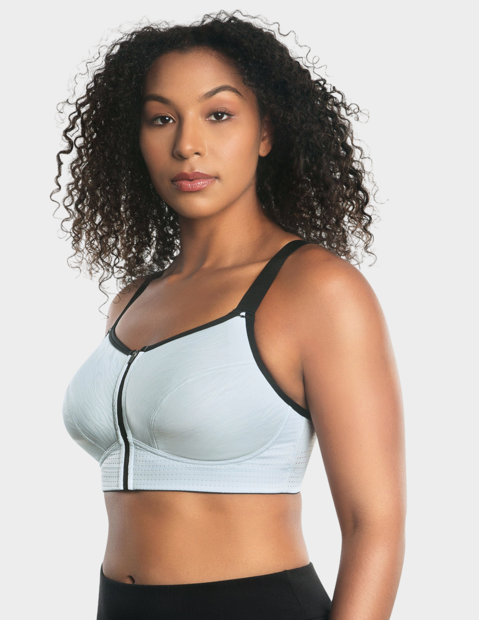 Side view of a model wearing Parfait Wave sports bra in Silver
