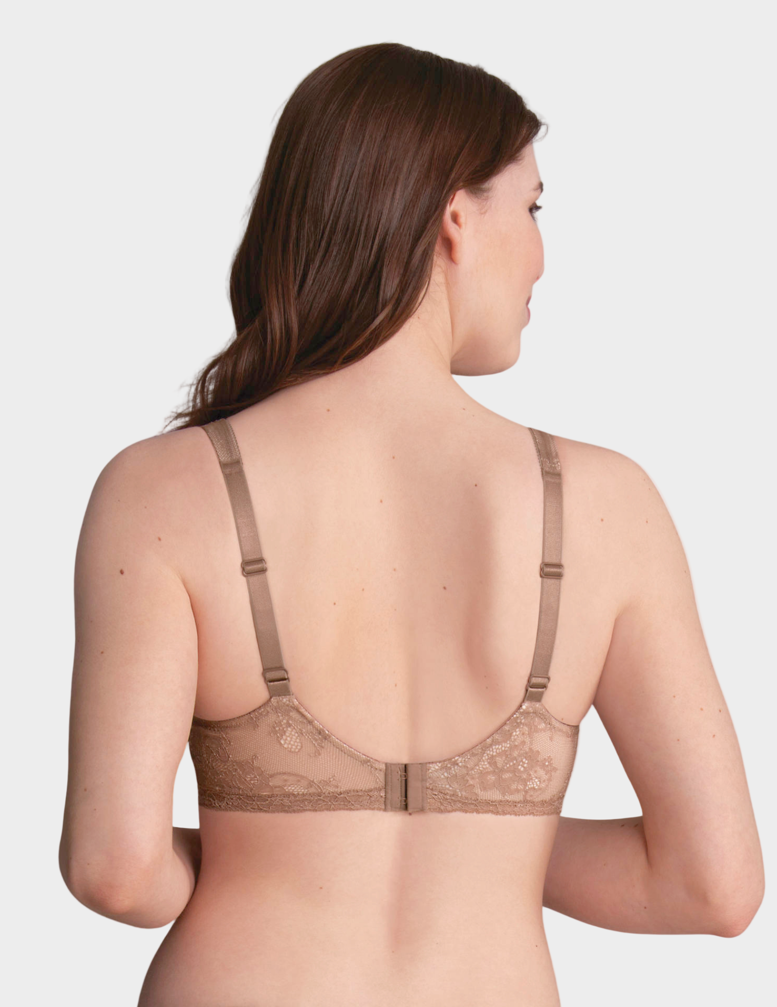 Woman wearing a beige bra on a white background