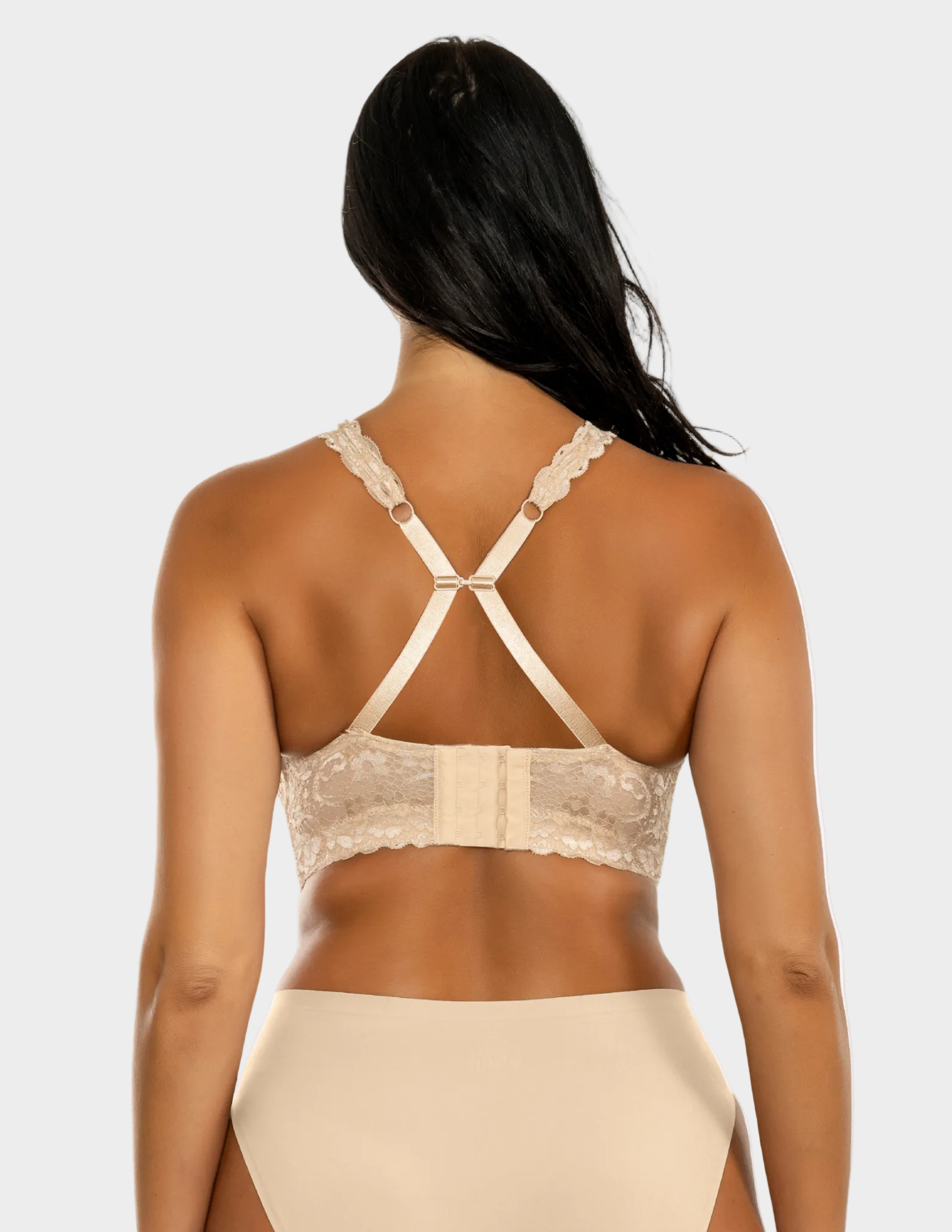 Back view of a model wearing beige Adriana lace bralette with straps hooked together