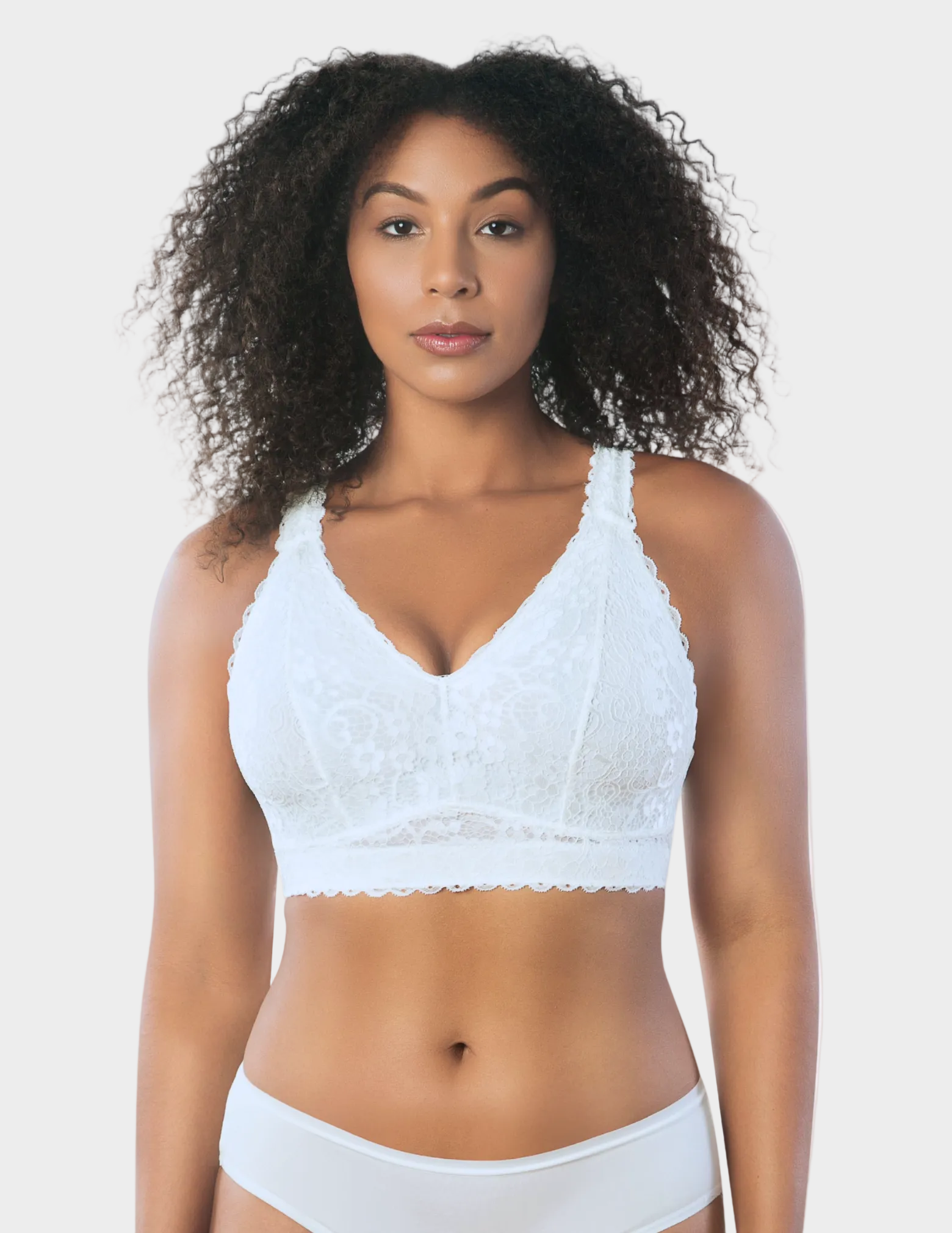 Front view of a model wearing white Adriana lace bralette
