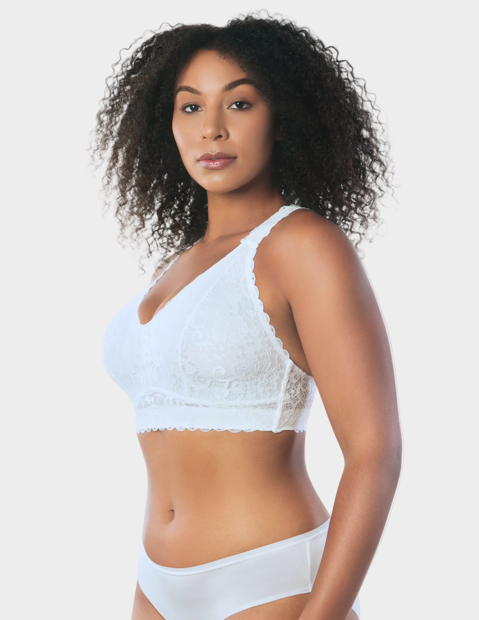 Side view of a model wearing white Adriana lace bralette