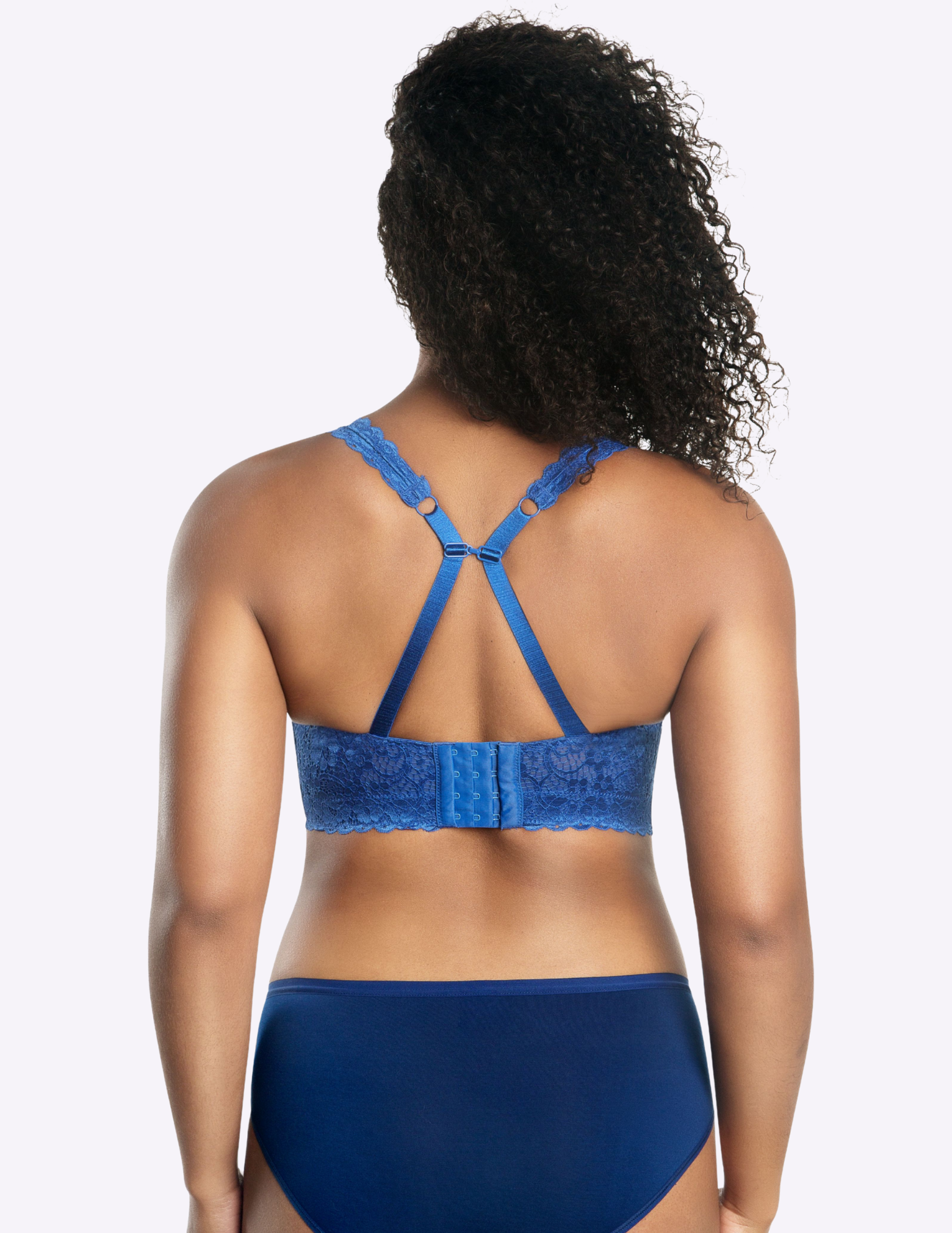 Back view of a model wearing blue Adriana lace bralette with straps hooked together